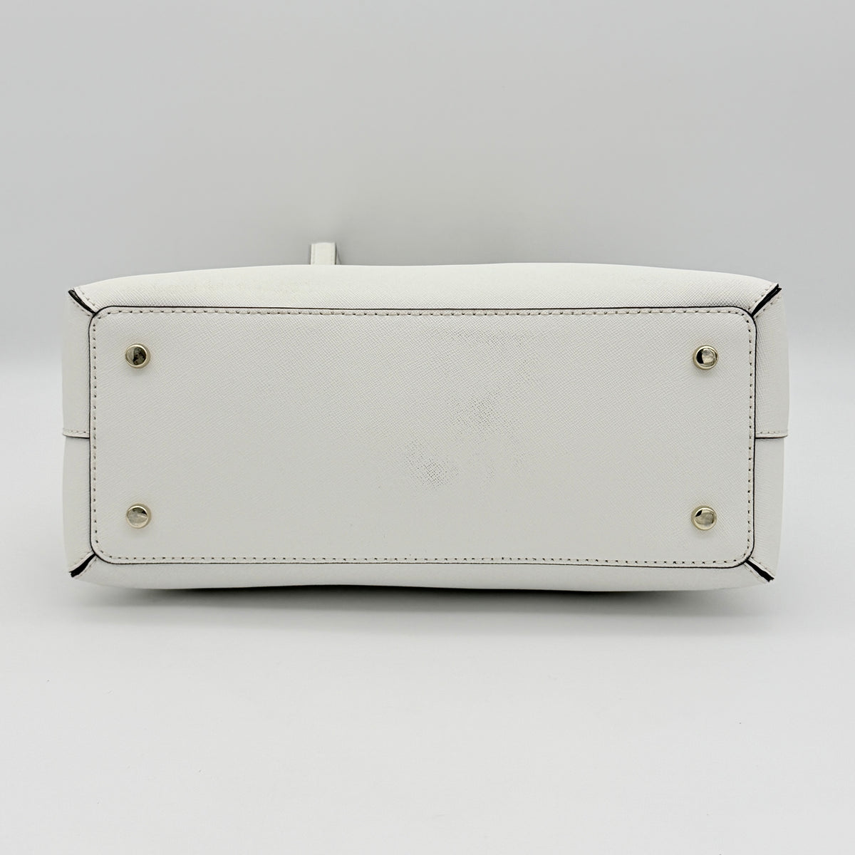 Top view of the Kate Spade Cedar Street Maise satchel in ivory, showing its spacious polka dot interior and zip pocket detail.