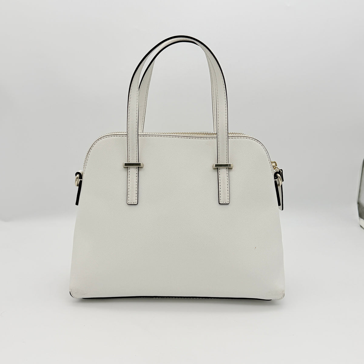 Top view of the Kate Spade Cedar Street Maise satchel in ivory, showing its spacious polka dot interior and zip pocket detail.