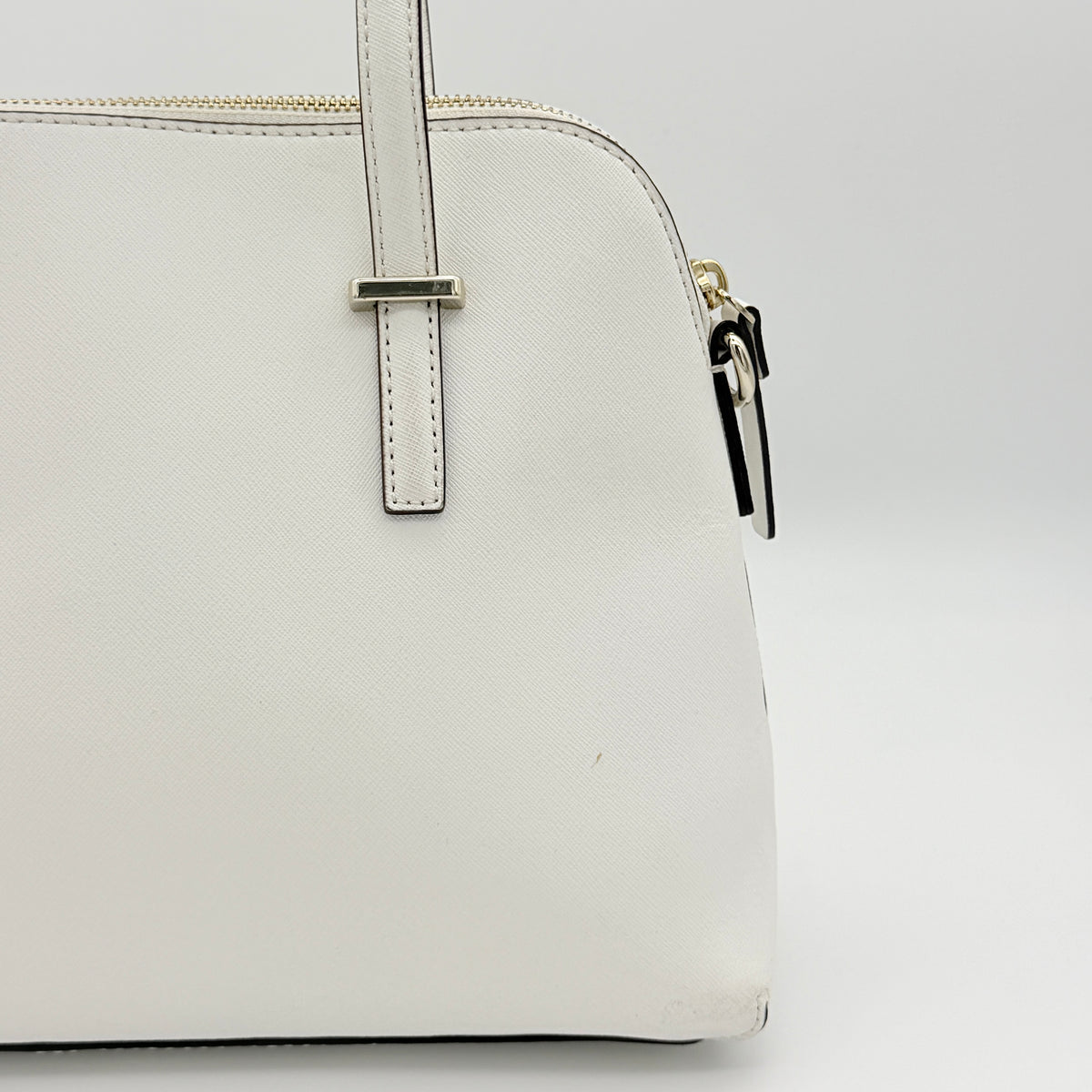 Top view of the Kate Spade Cedar Street Maise satchel in ivory, showing its spacious polka dot interior and zip pocket detail.