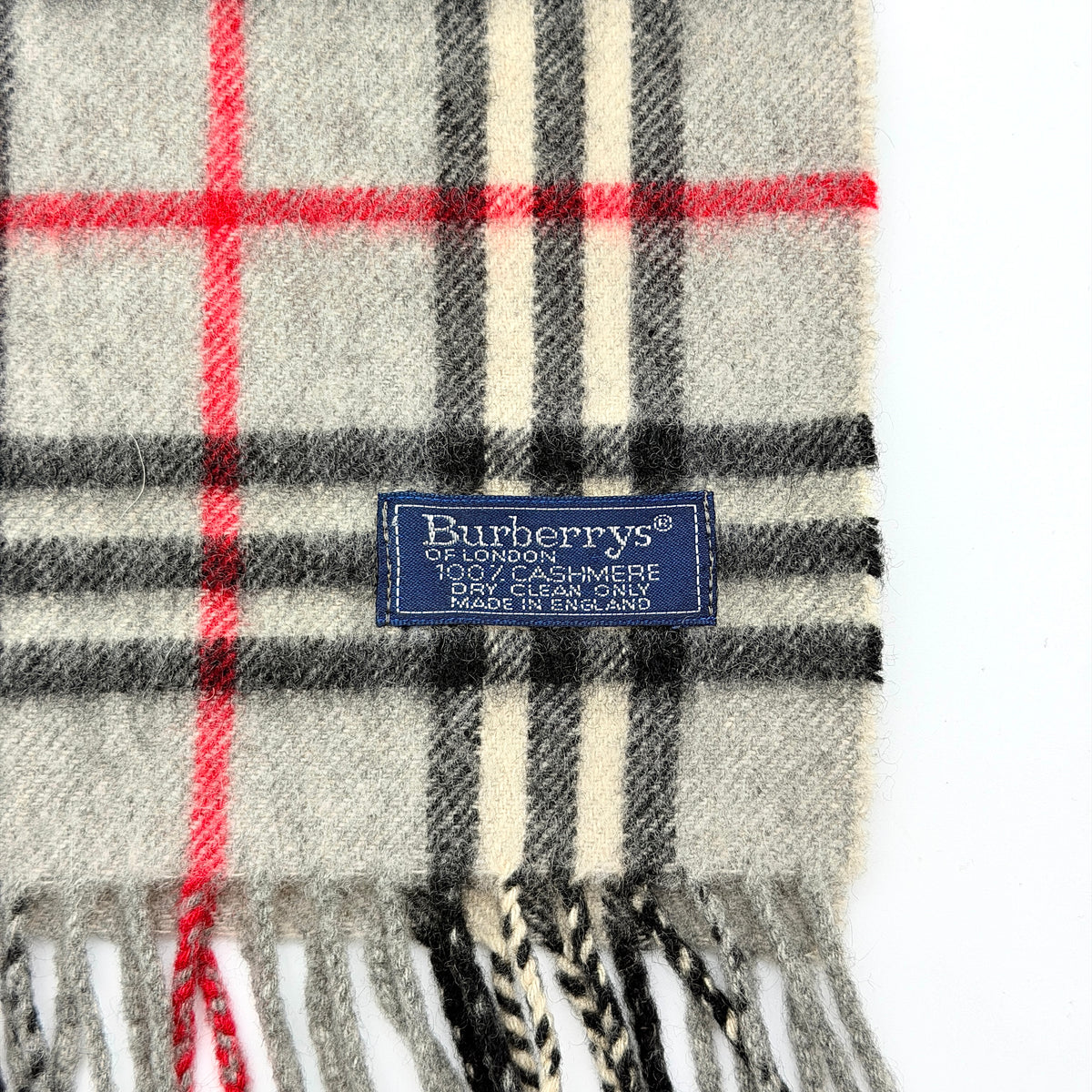 Burberry London grey Nova Check cashmere scarf with classic check pattern and fringe ends, shown carefully folded.
