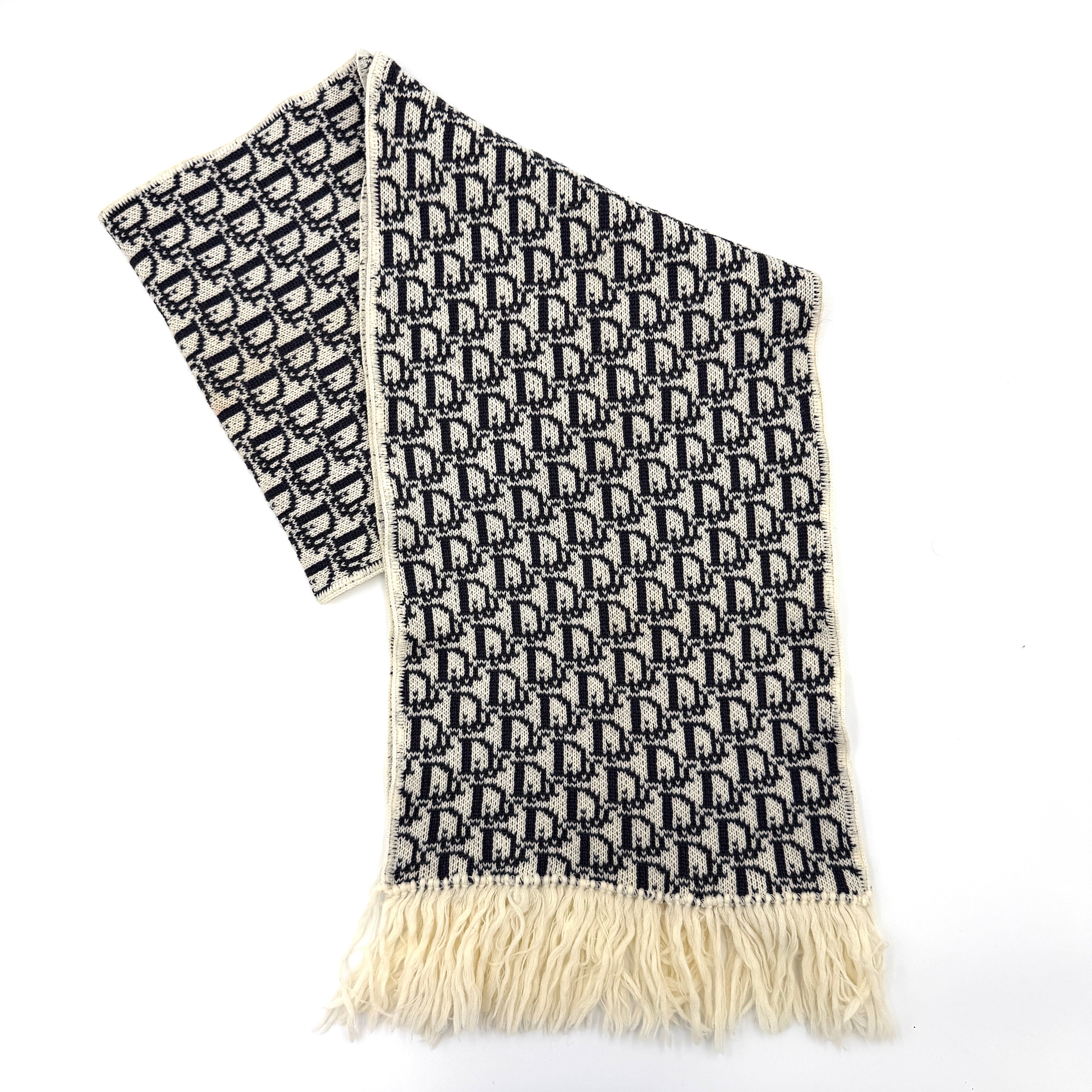 Dior Trotter Monogram wool scarf in white and black with all-over Dior logo pattern and fringe trim, elegantly displayed.