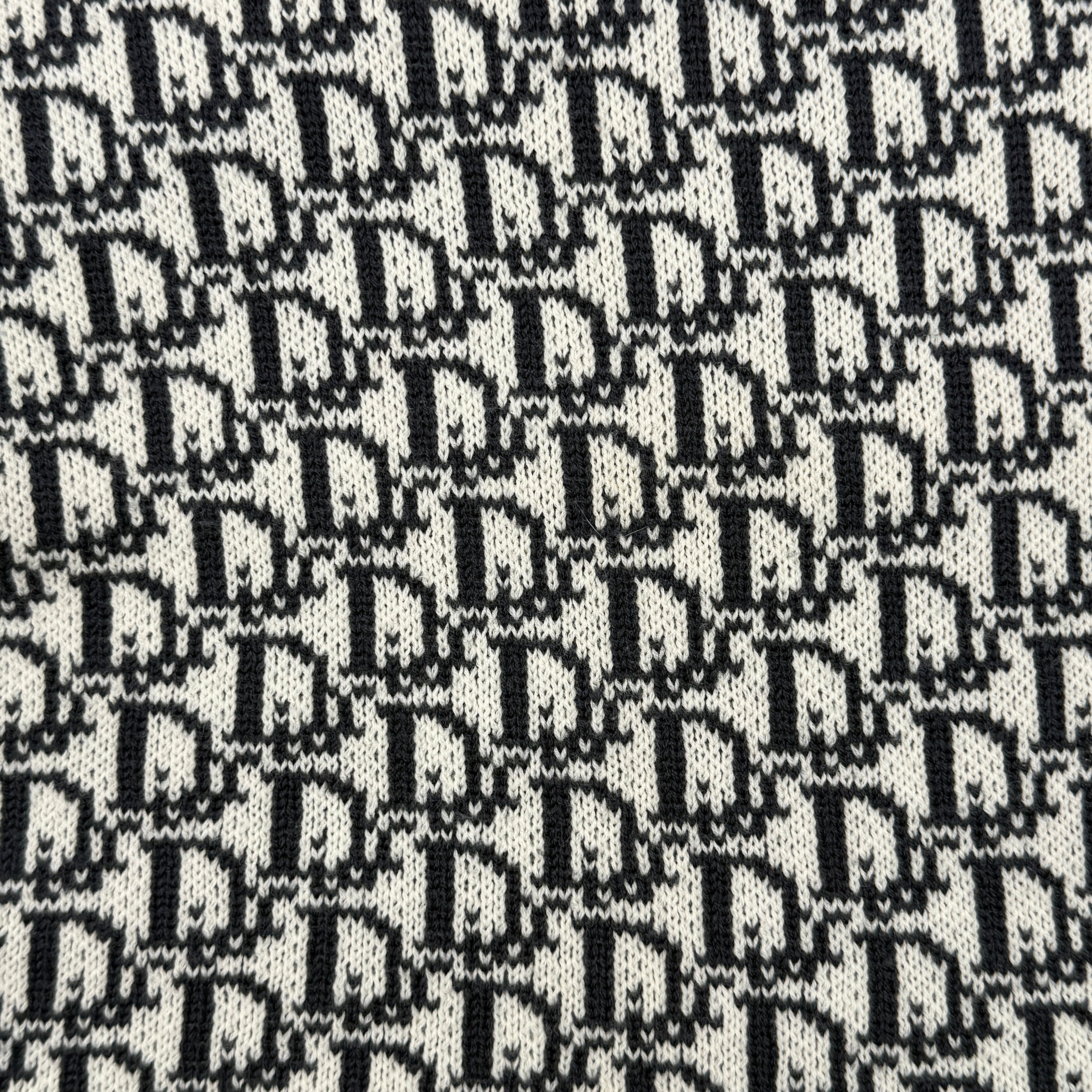 Dior Trotter Monogram wool scarf in white and black with all-over Dior logo pattern and fringe trim, elegantly displayed.
