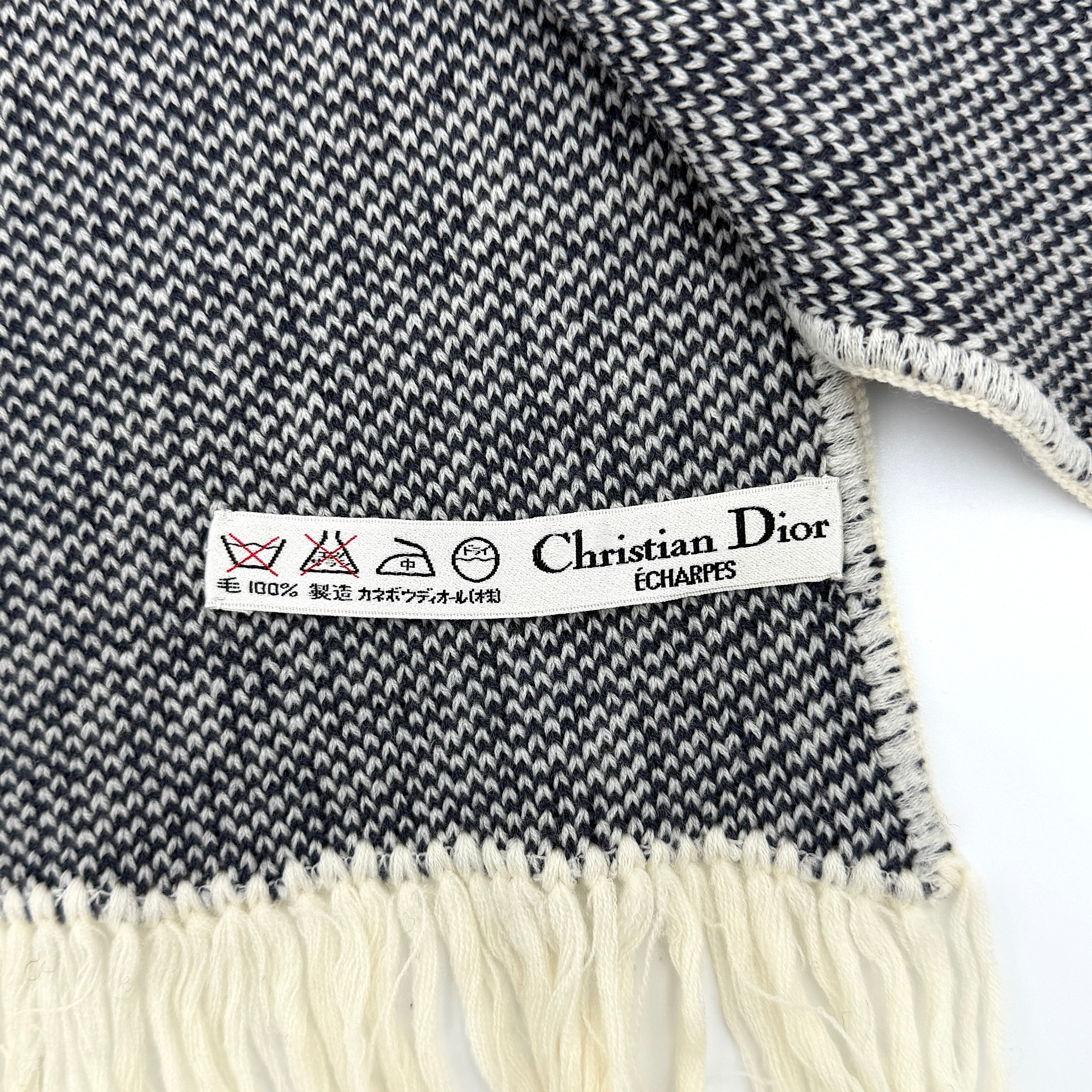Dior Trotter Monogram wool scarf in white and black with all-over Dior logo pattern and fringe trim, elegantly displayed.
