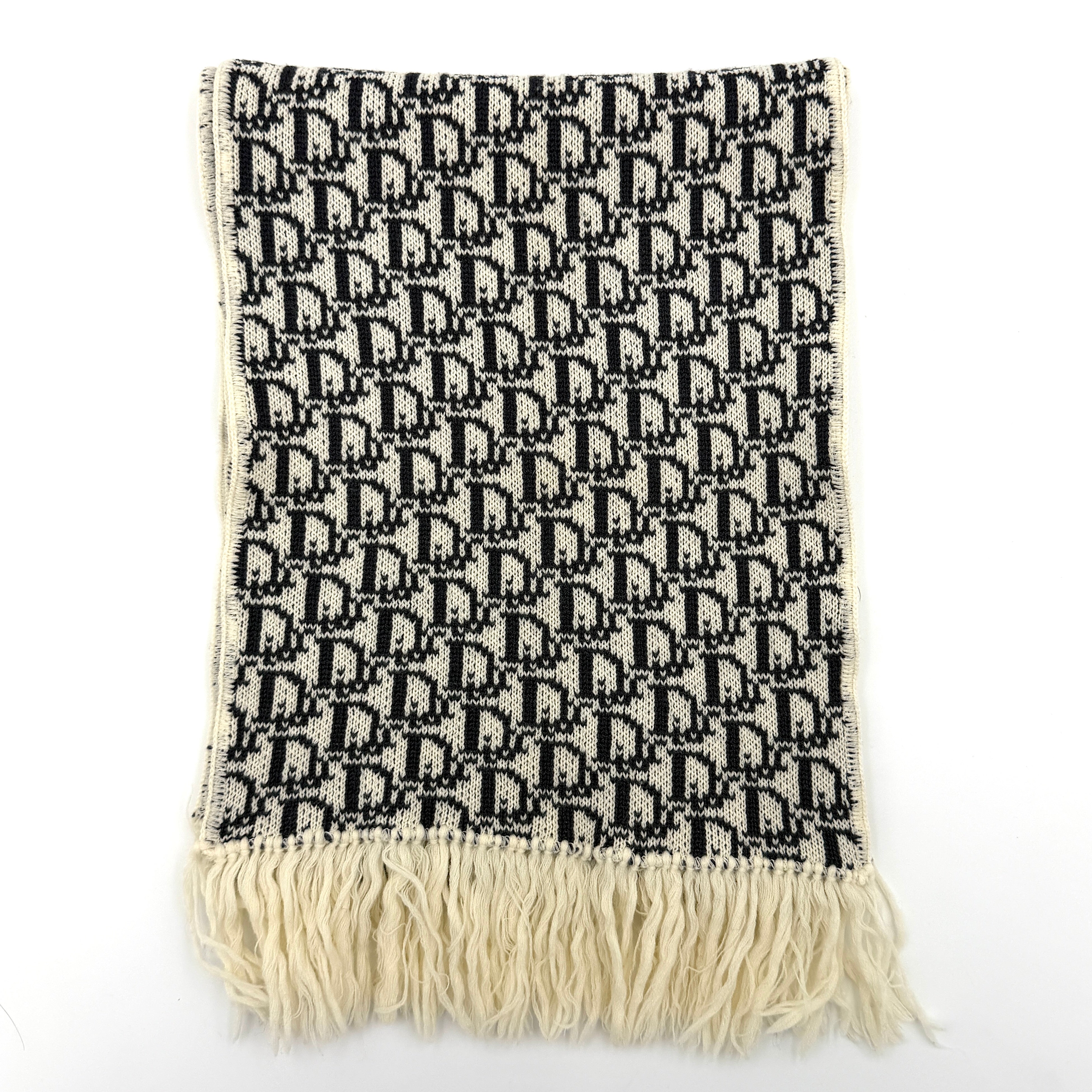 Dior Trotter Monogram wool scarf in white and black with all-over Dior logo pattern and fringe trim, elegantly displayed.