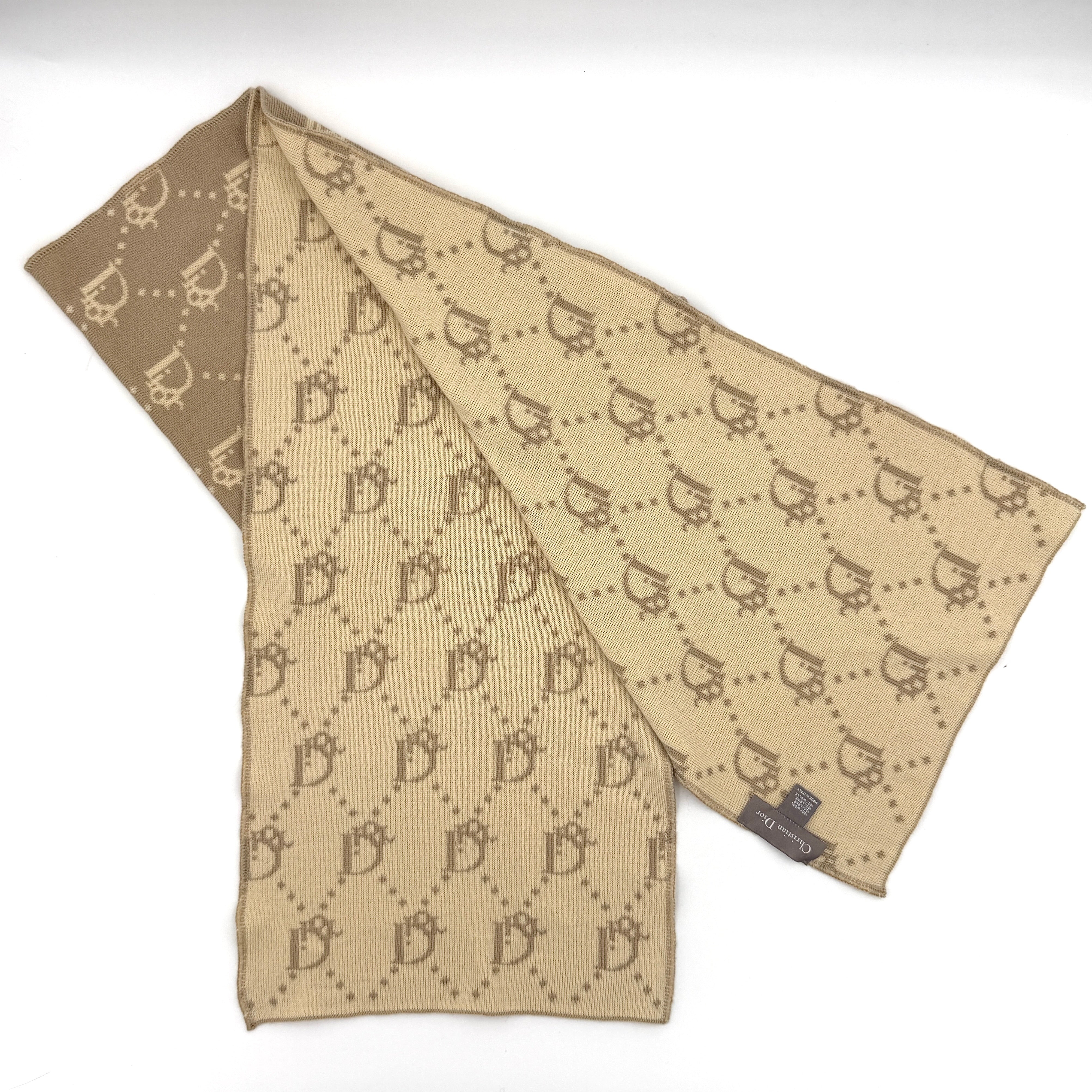 Beige Dior wool scarf featuring an all-over monogram jacquard pattern, elegantly displayed to reveal both sides' colour contrast.