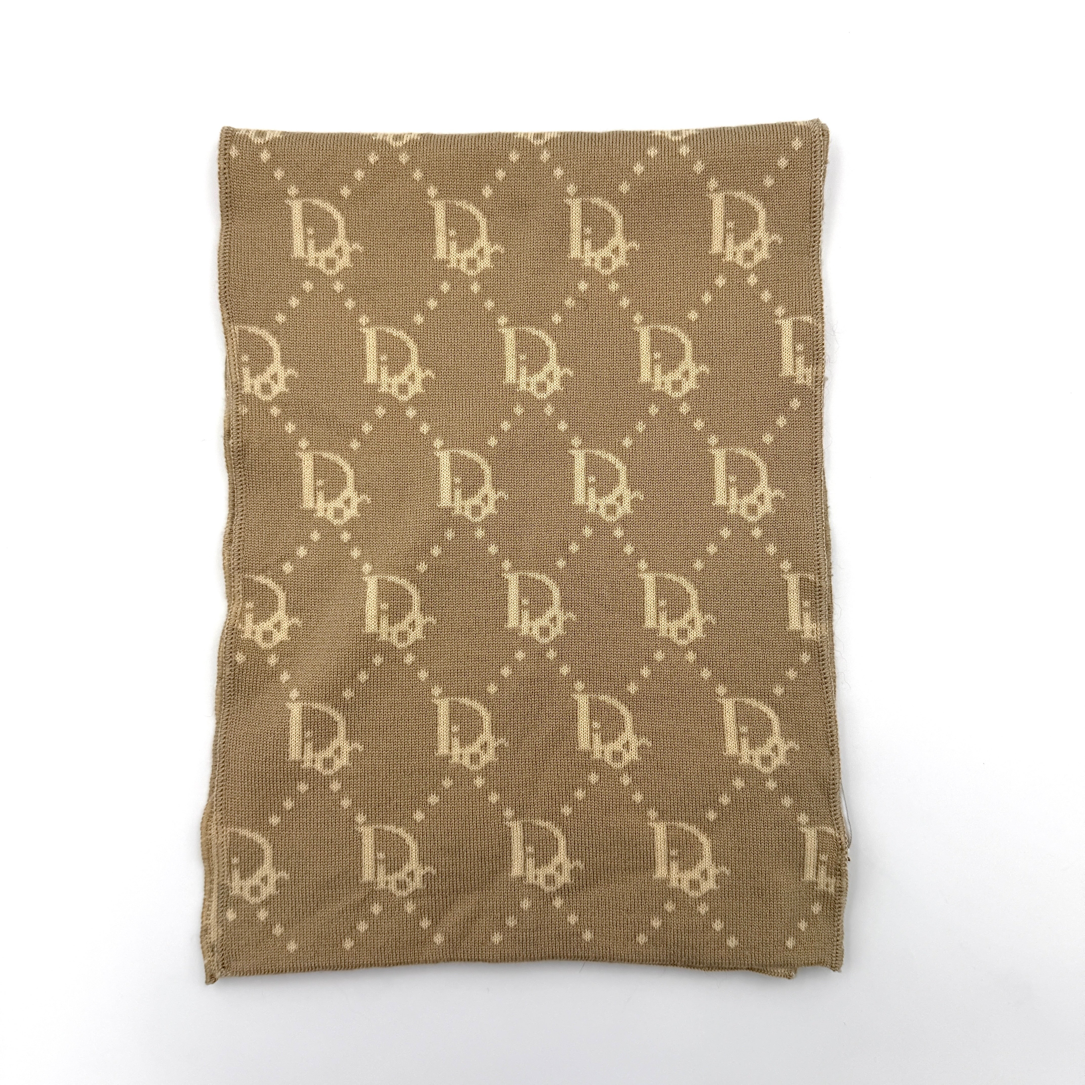 Beige Dior wool scarf featuring an all-over monogram jacquard pattern, elegantly displayed to reveal both sides' colour contrast.