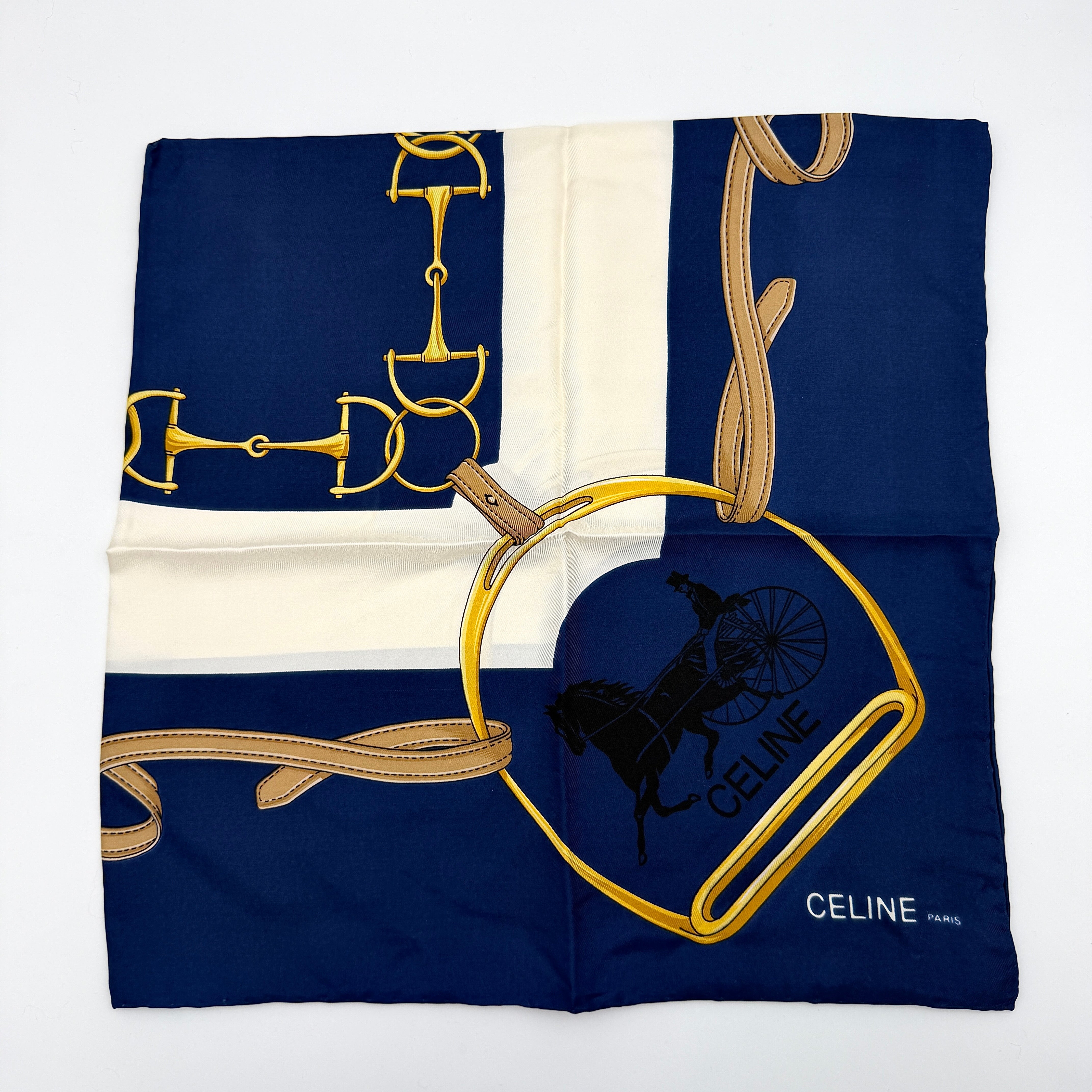 Celine silk scarf in navy blue with equestrian-inspired yellow and tan rein motif and carriage logo on silk.