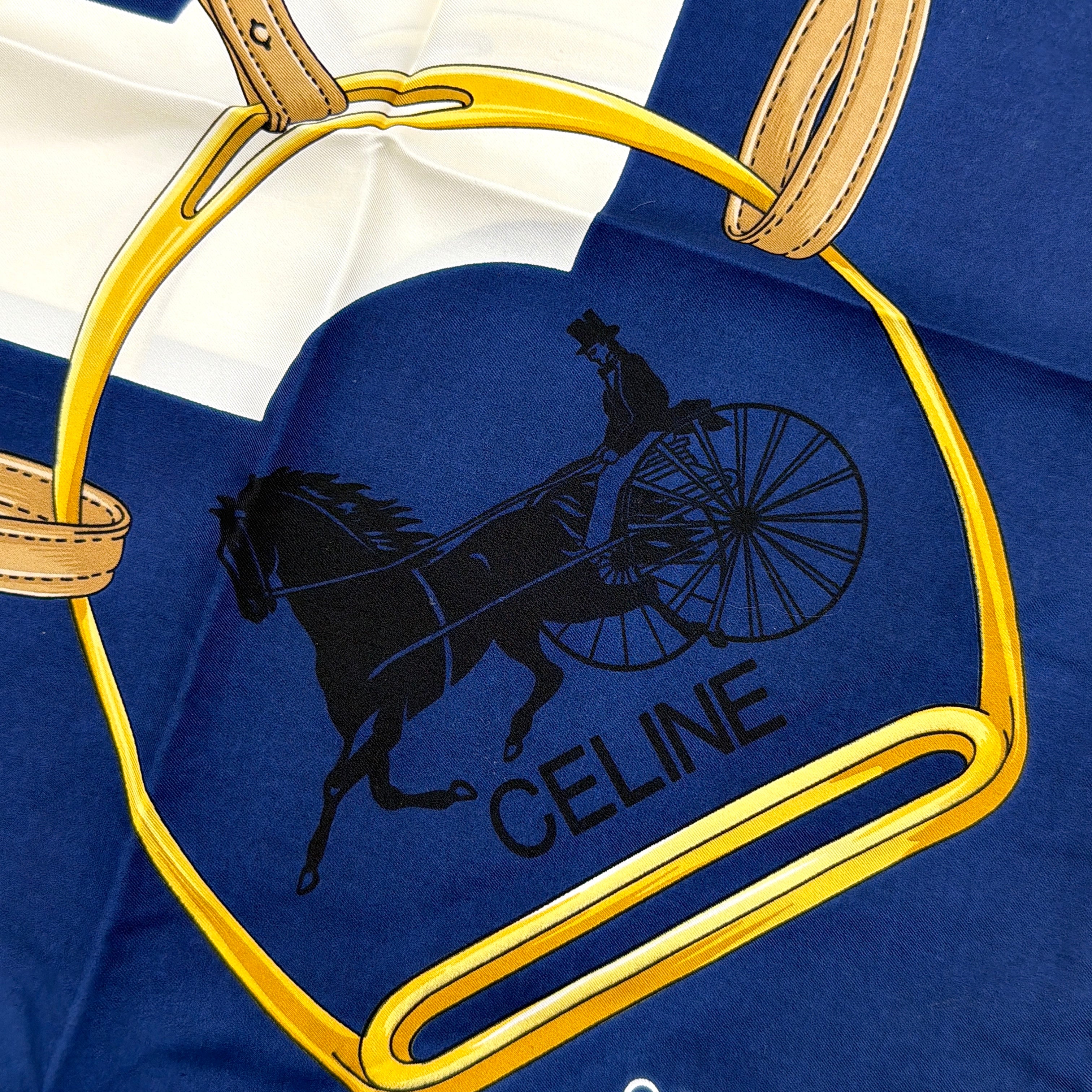 Celine silk scarf in navy blue with equestrian-inspired yellow and tan rein motif and carriage logo on silk.
