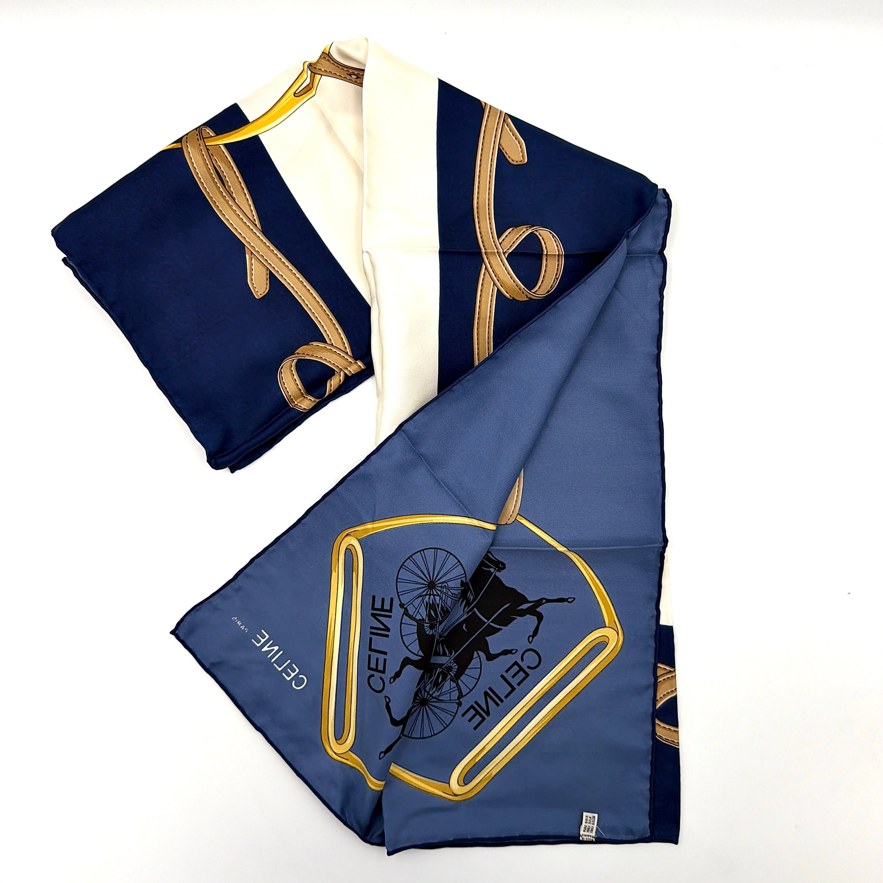 Celine silk scarf in navy blue with equestrian-inspired yellow and tan rein motif and carriage logo on silk.