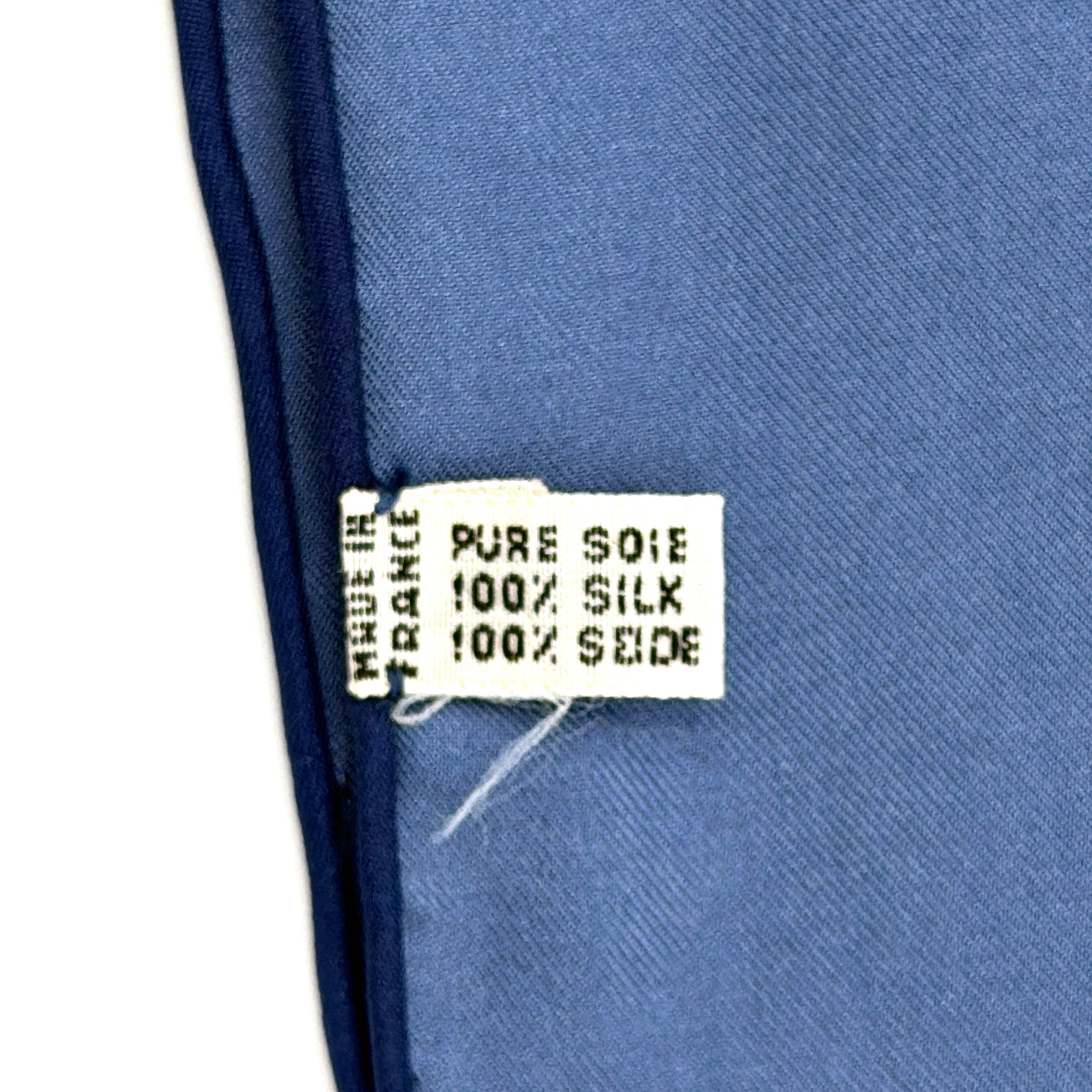 Celine silk scarf in navy blue with equestrian-inspired yellow and tan rein motif and carriage logo on silk.