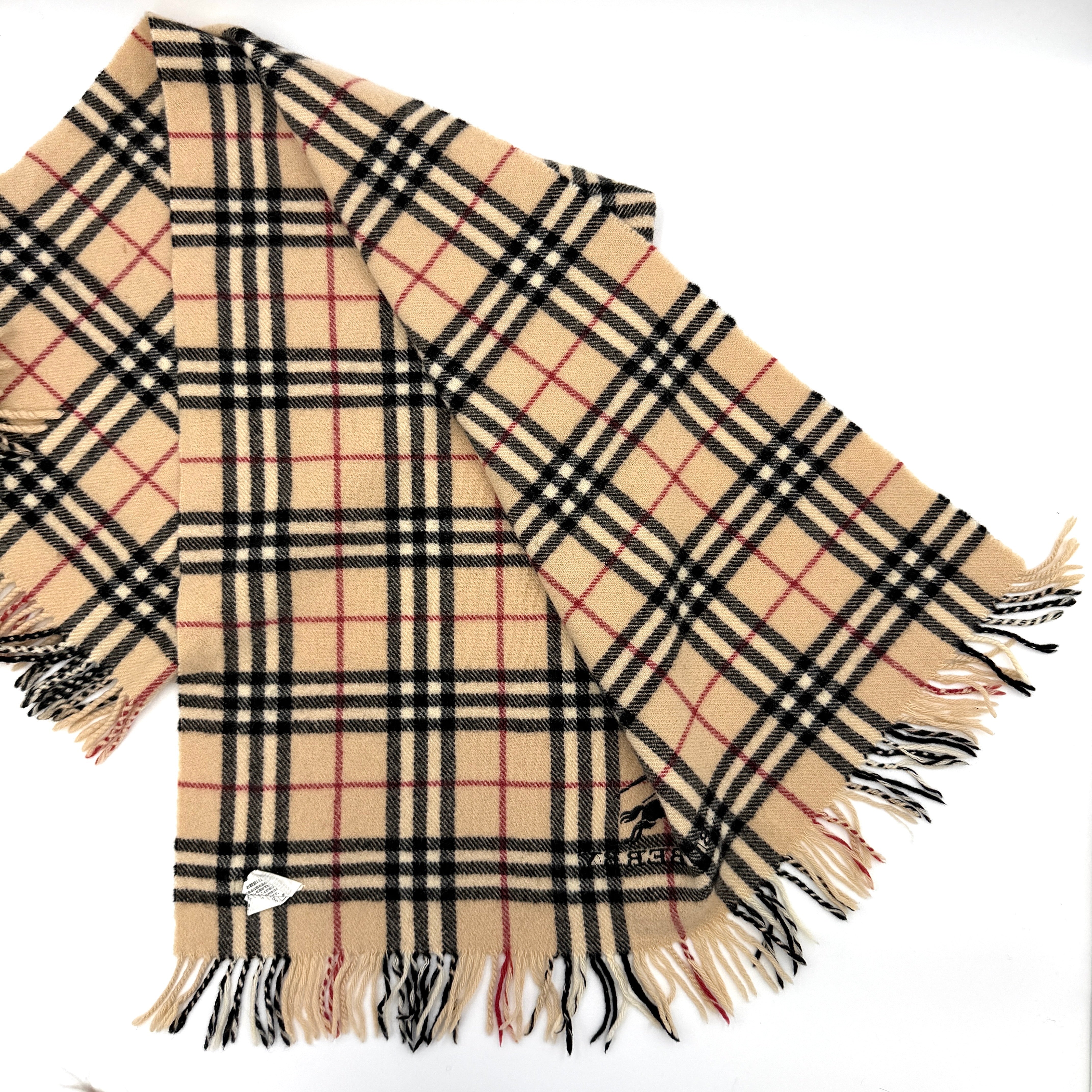 Burberry Nova Check wool scarf with fringed edges and embroidered logo in a beige, black, and red tartan pattern.
