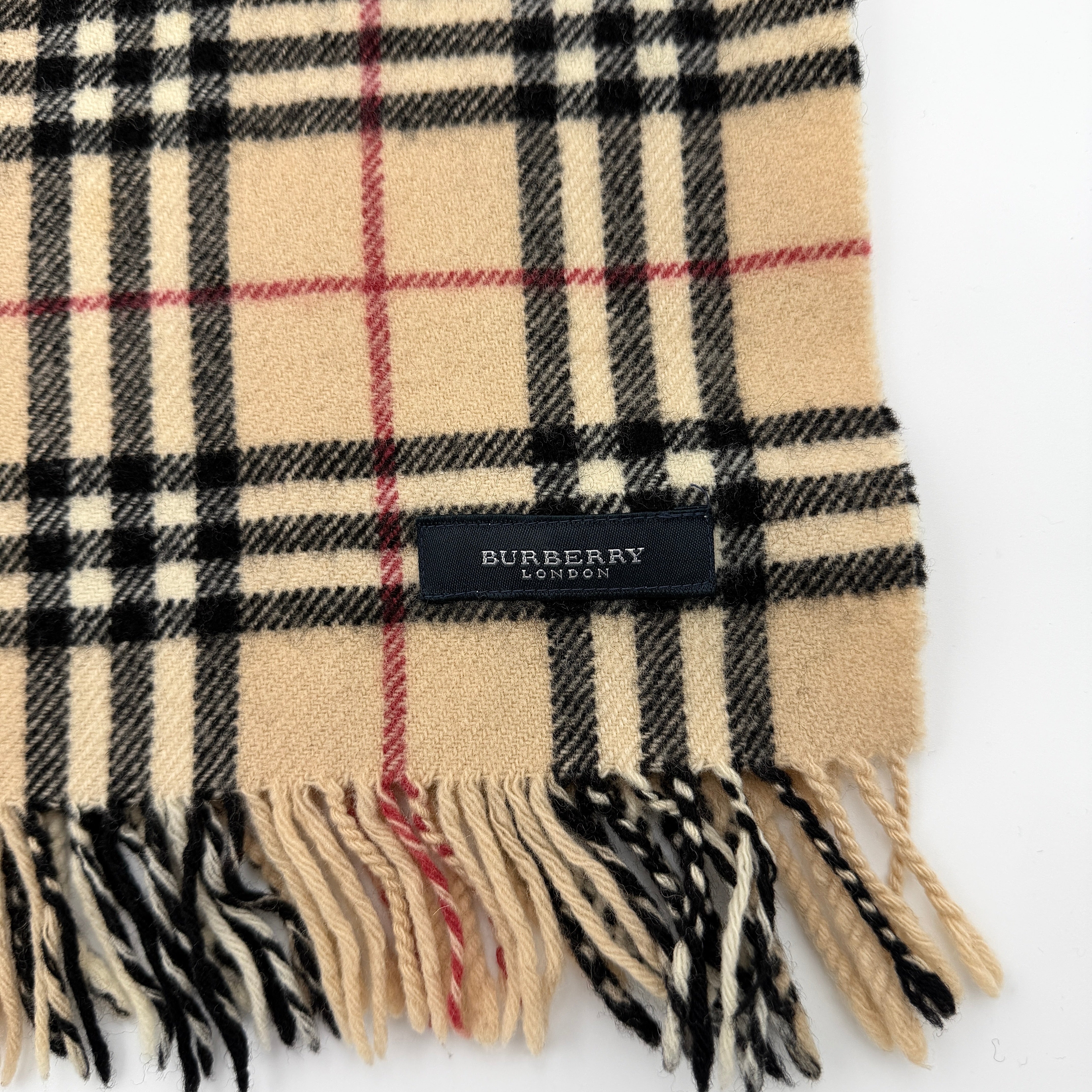 Burberry Nova Check wool scarf with fringed edges and embroidered logo in a beige, black, and red tartan pattern.