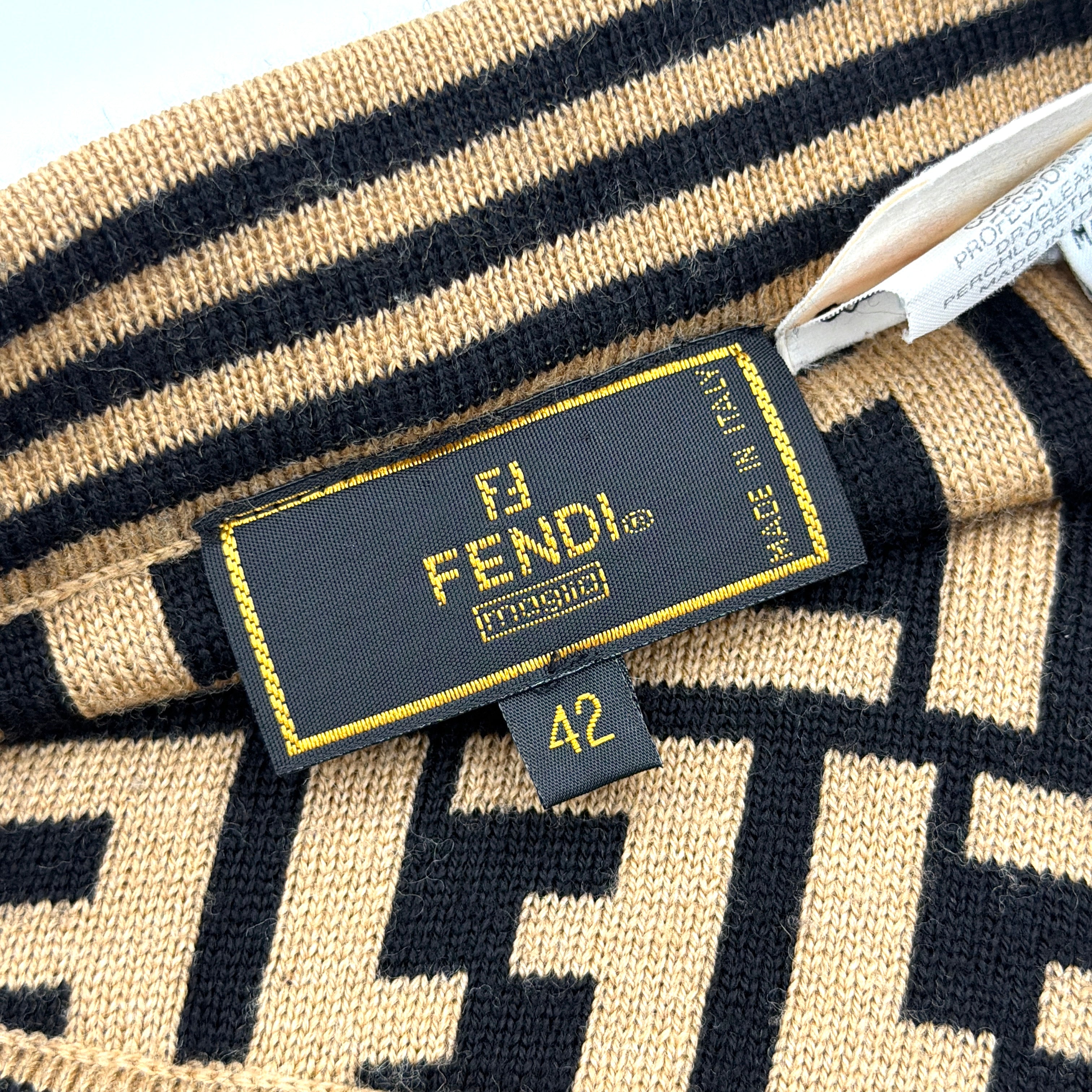 Fendi brown knit skirt with bold black FF Zucca monogram and side stripe detail, displayed flat to showcase its sculpted silhouette.