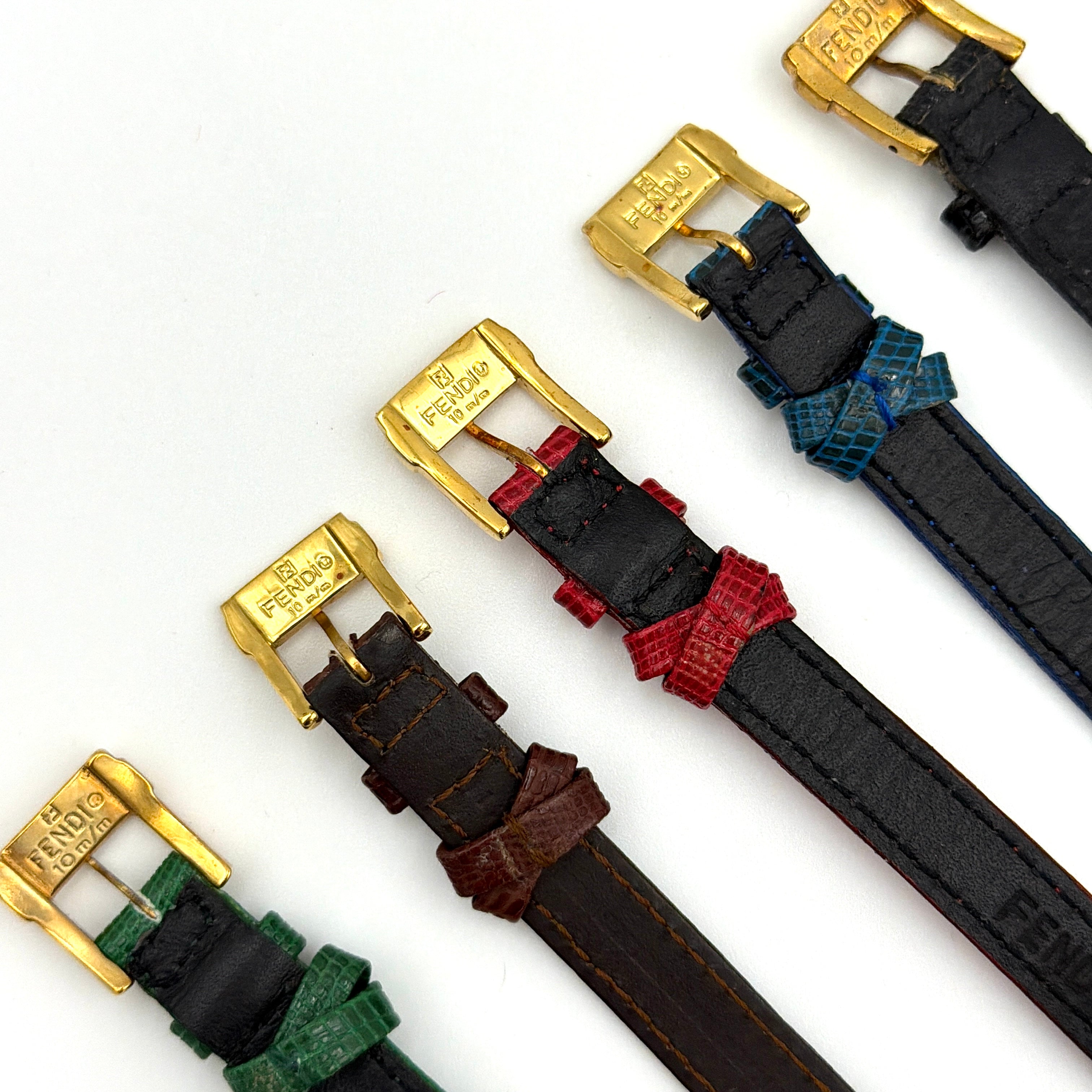 Fendi 640L Chameleon watch with five colored leather straps and gold-tone case displayed in a row.