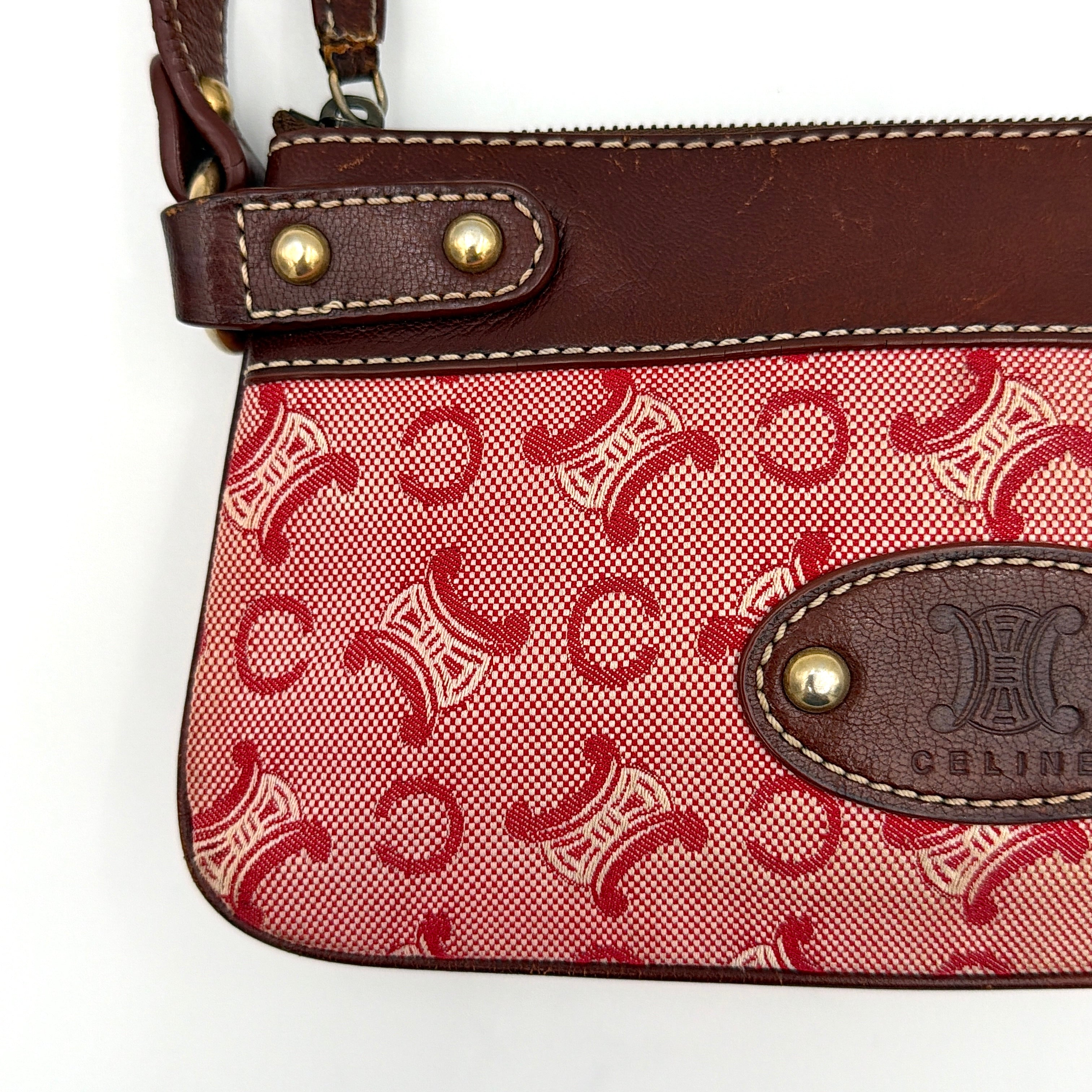 Celine Macadam shoulder bag in red coated canvas with brown leather trim and gold-tone hardware.
