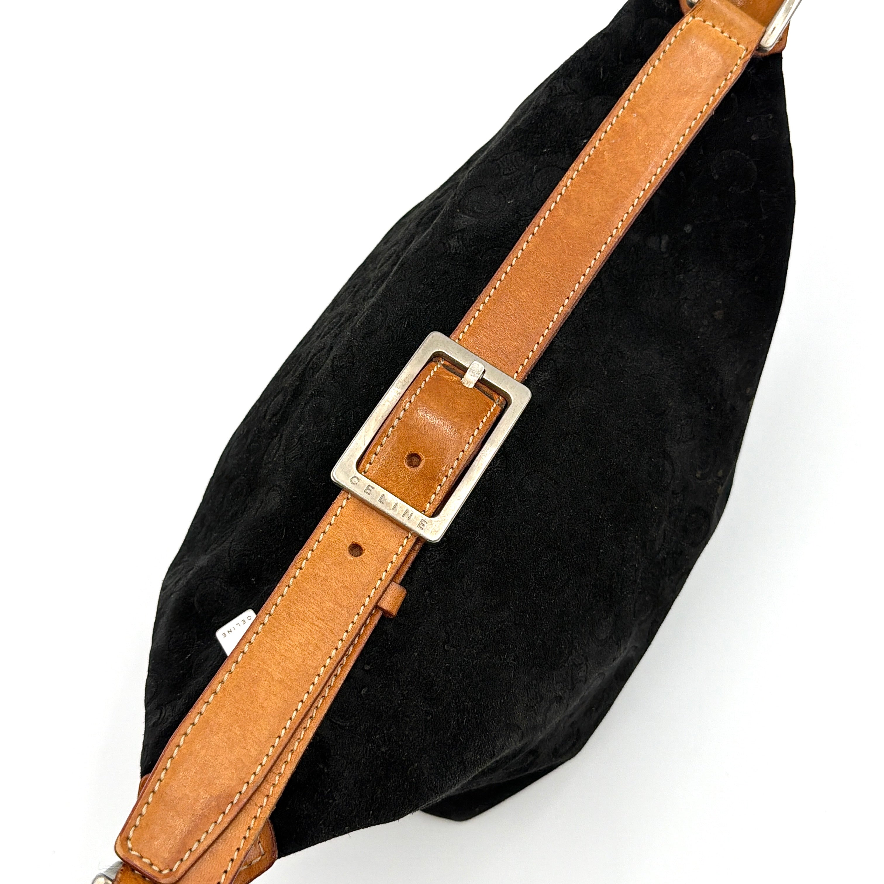 Celine black suede shoulder bag with embossed Triomphe motif, tan leather strap and silver-tone hardware, displayed from the front.