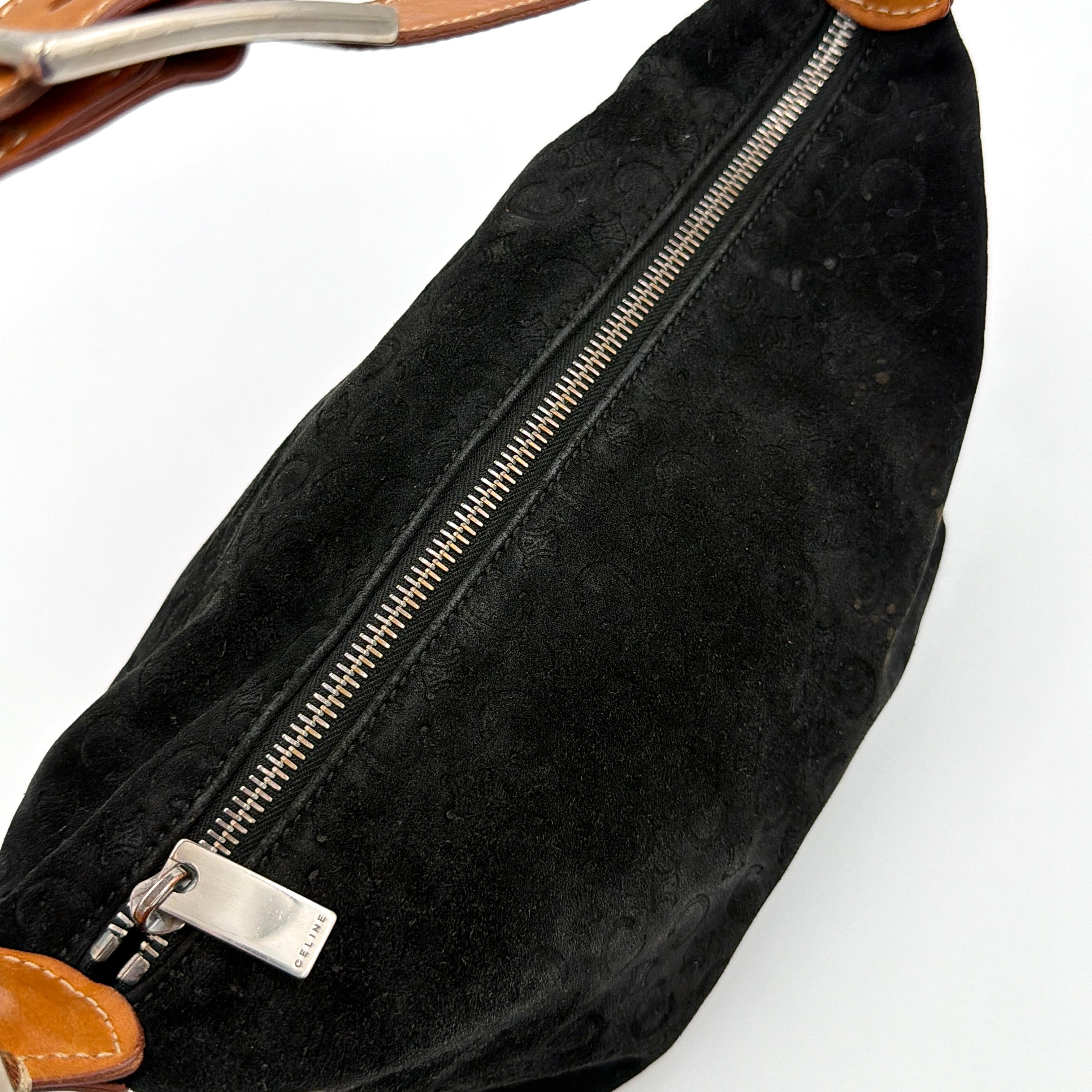 Celine black suede shoulder bag with embossed Triomphe motif, tan leather strap and silver-tone hardware, displayed from the front.