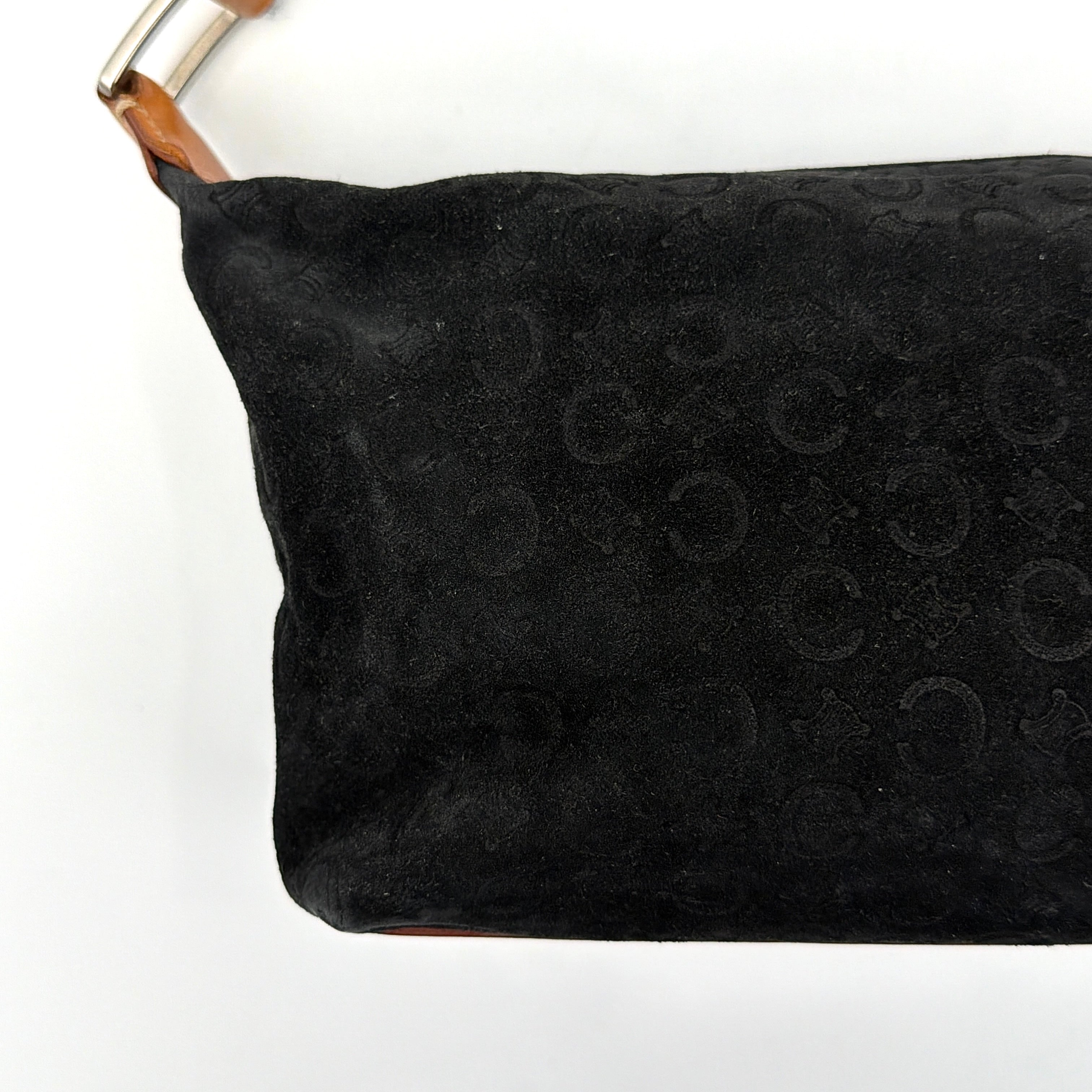 Celine black suede shoulder bag with embossed Triomphe motif, tan leather strap and silver-tone hardware, displayed from the front.