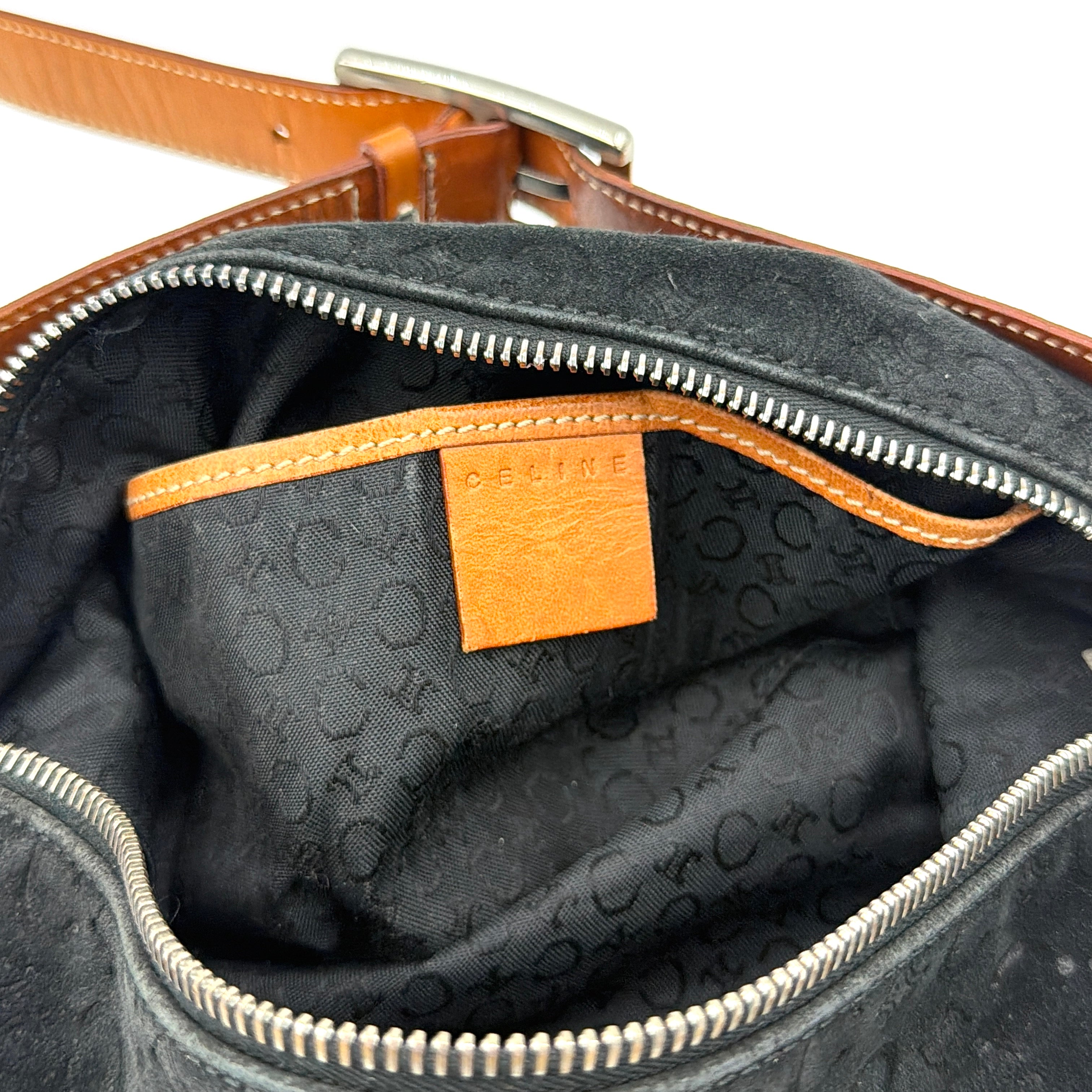 Celine black suede shoulder bag with embossed Triomphe motif, tan leather strap and silver-tone hardware, displayed from the front.