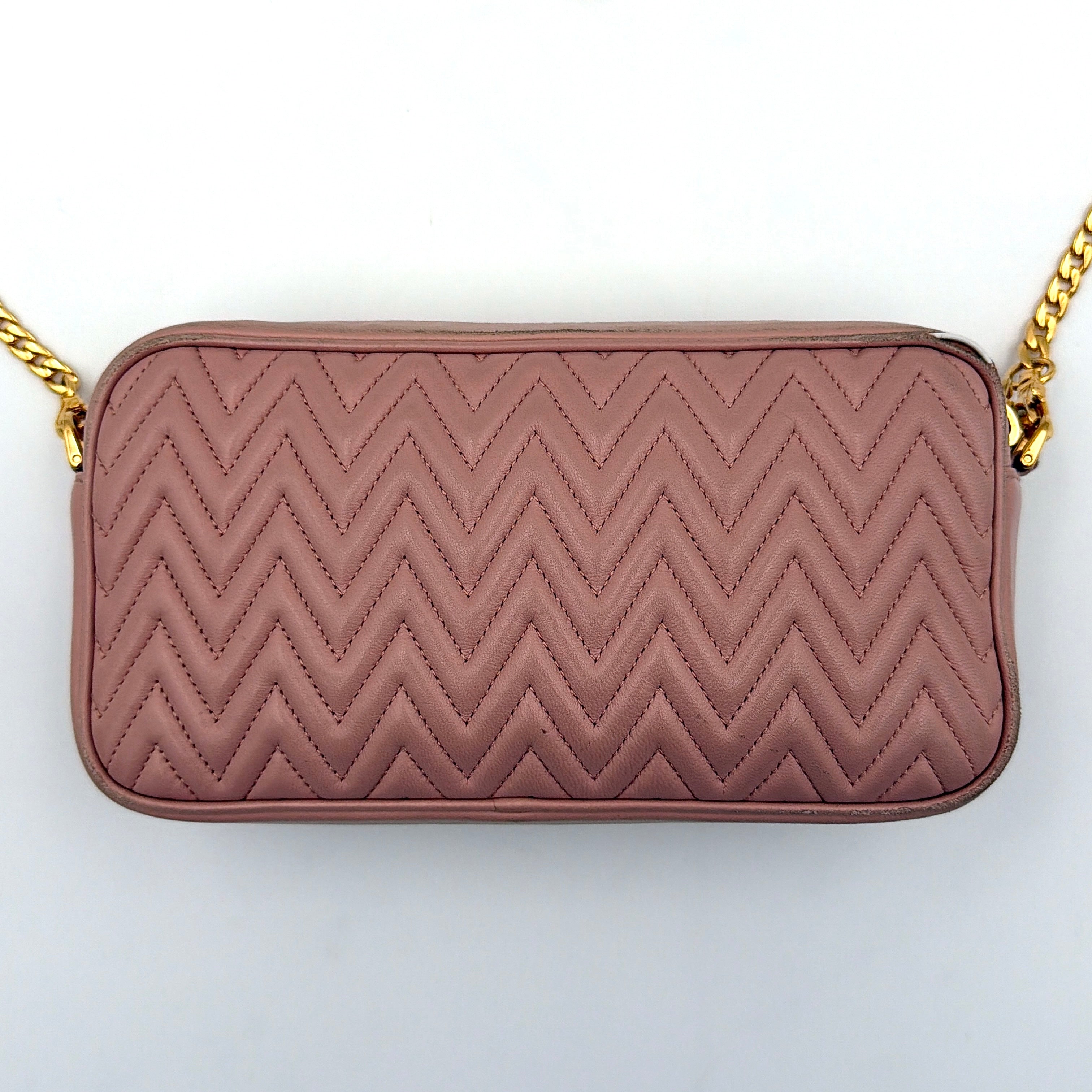 Miu Miu dusty pink quilted nappa mini crossbody bag with gold-tone chain strap and zip closure, showcased on a clean white background.