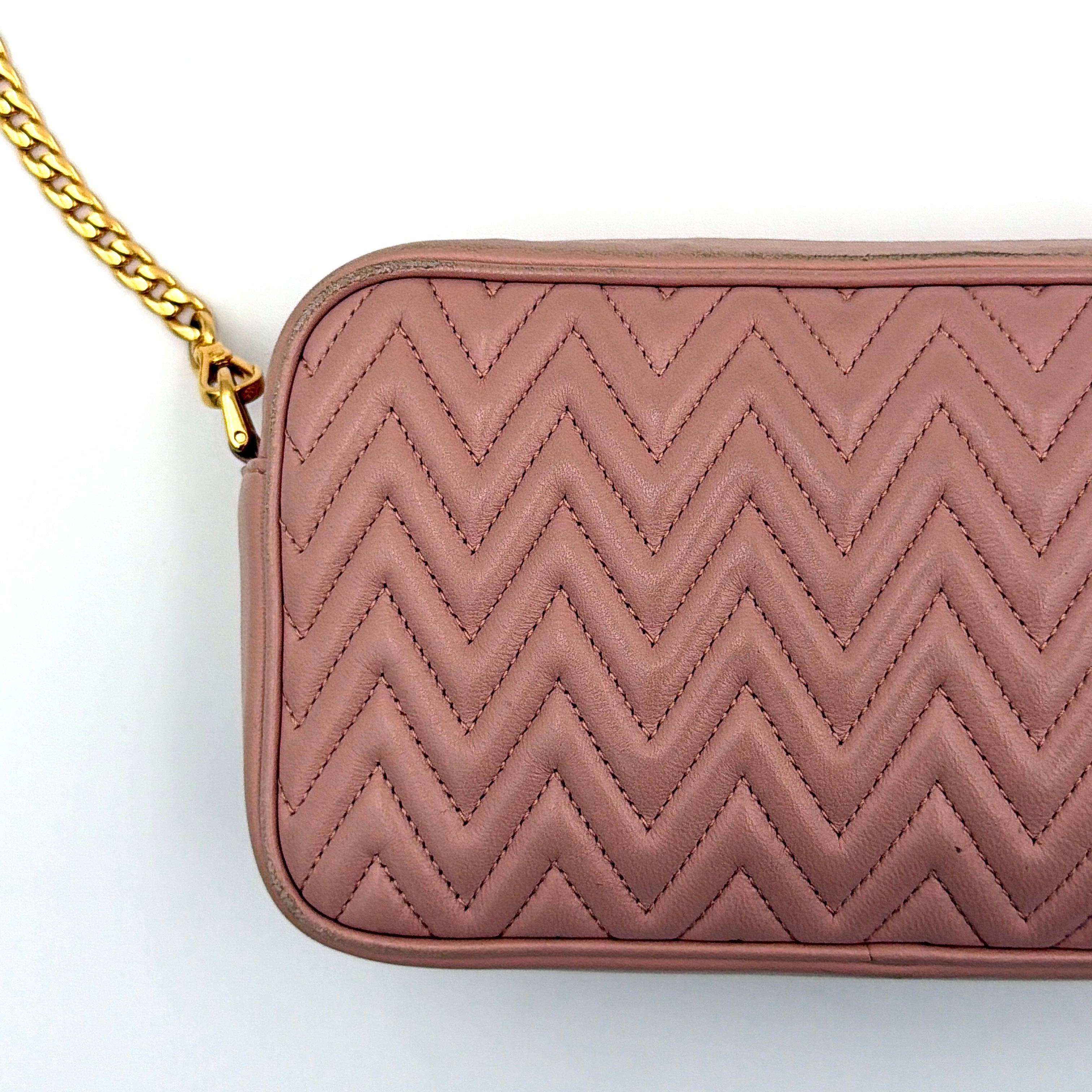 Miu Miu dusty pink quilted nappa mini crossbody bag with gold-tone chain strap and zip closure, showcased on a clean white background.