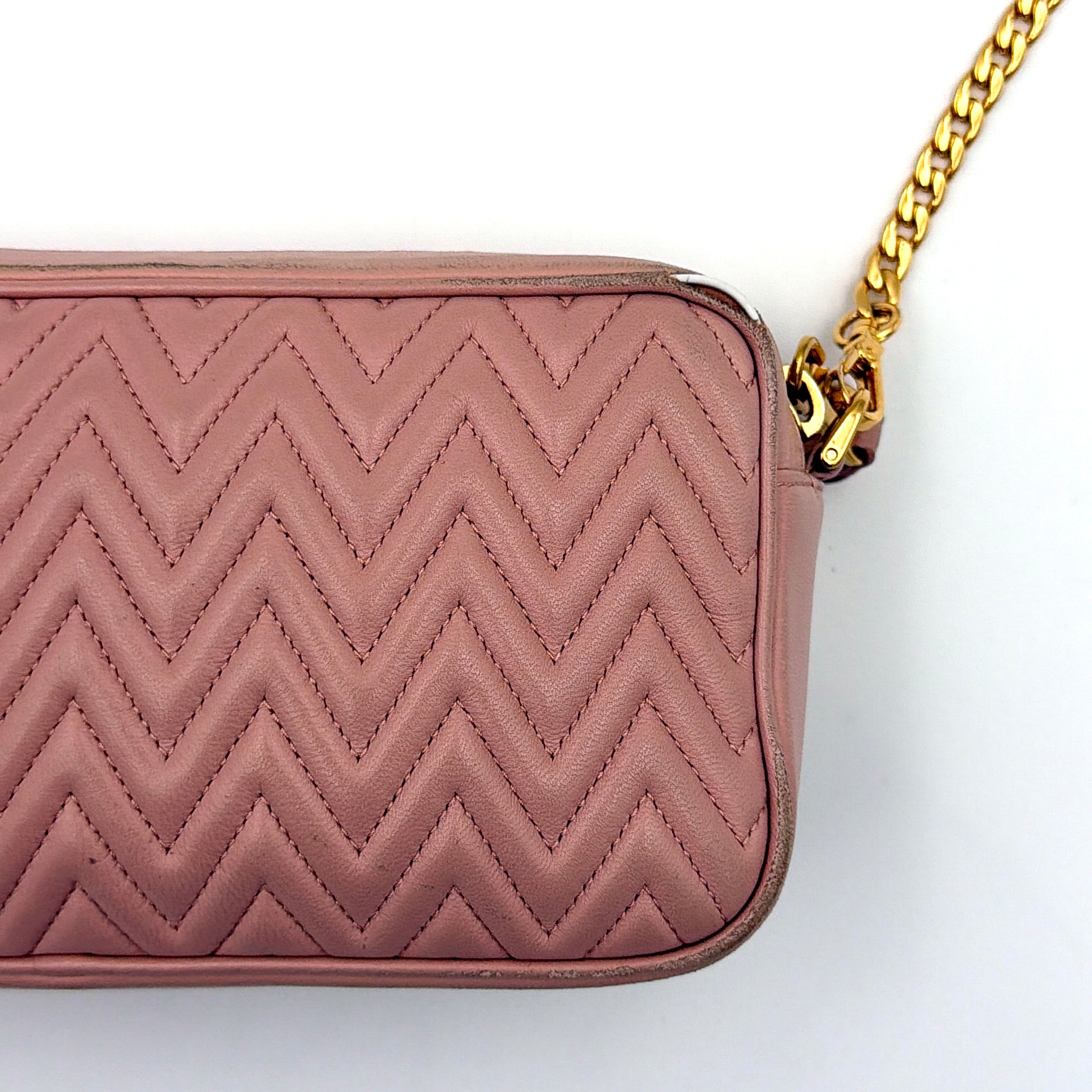 Miu Miu dusty pink quilted nappa mini crossbody bag with gold-tone chain strap and zip closure, showcased on a clean white background.