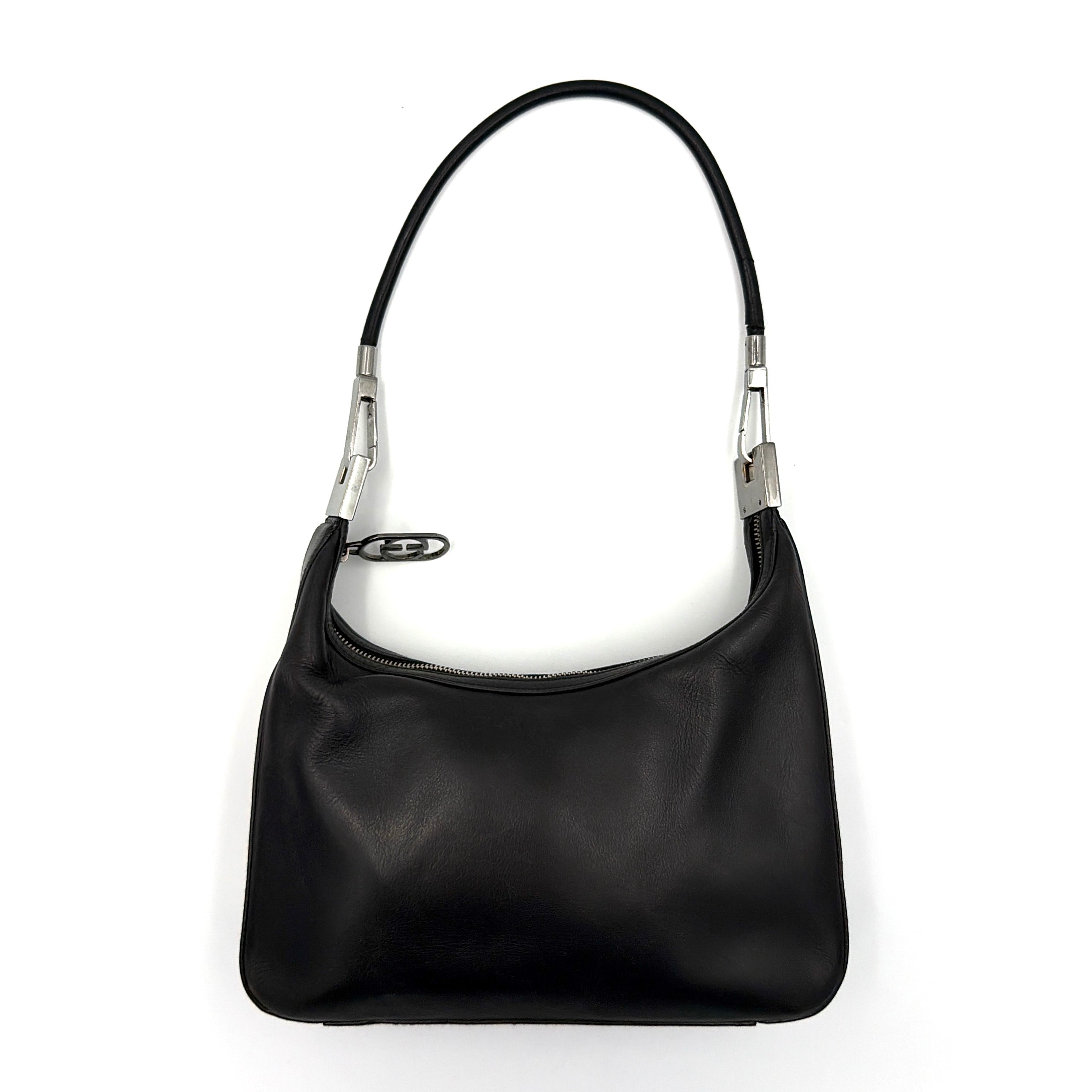 Gucci GG Leather Hobo Shoulder Bag in black smooth leather with sculptural silver-tone hardware and signature GG zip pull.