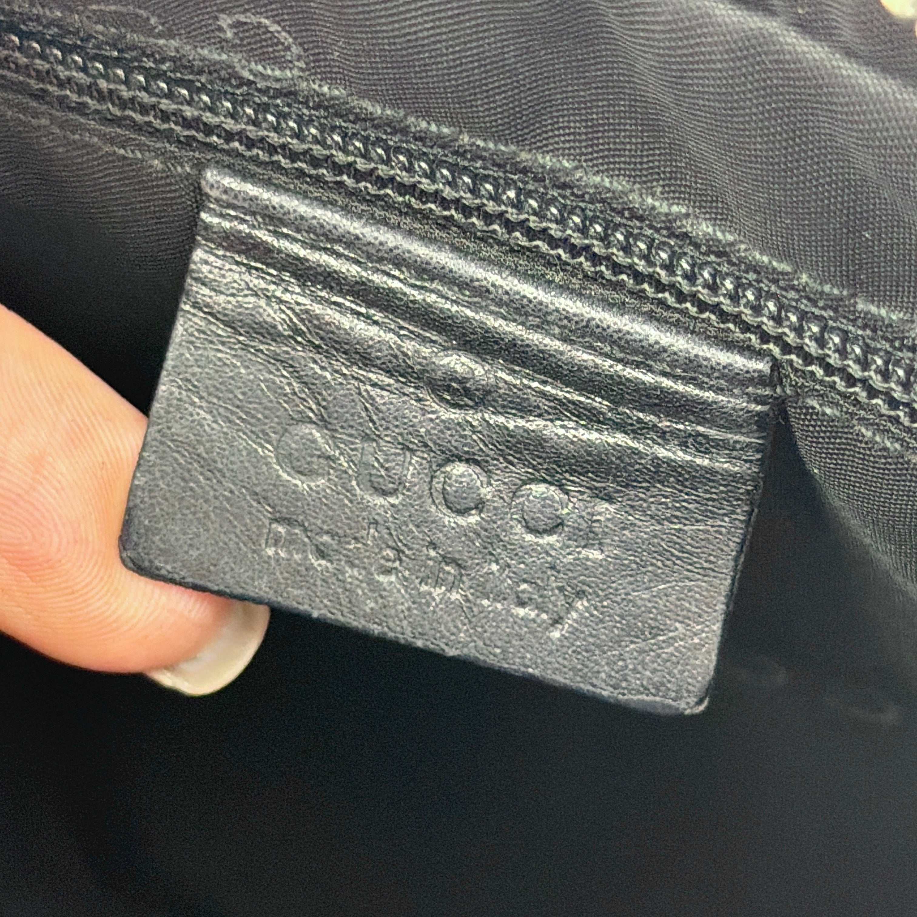 Gucci GG Leather Hobo Shoulder Bag in black smooth leather with sculptural silver-tone hardware and signature GG zip pull.