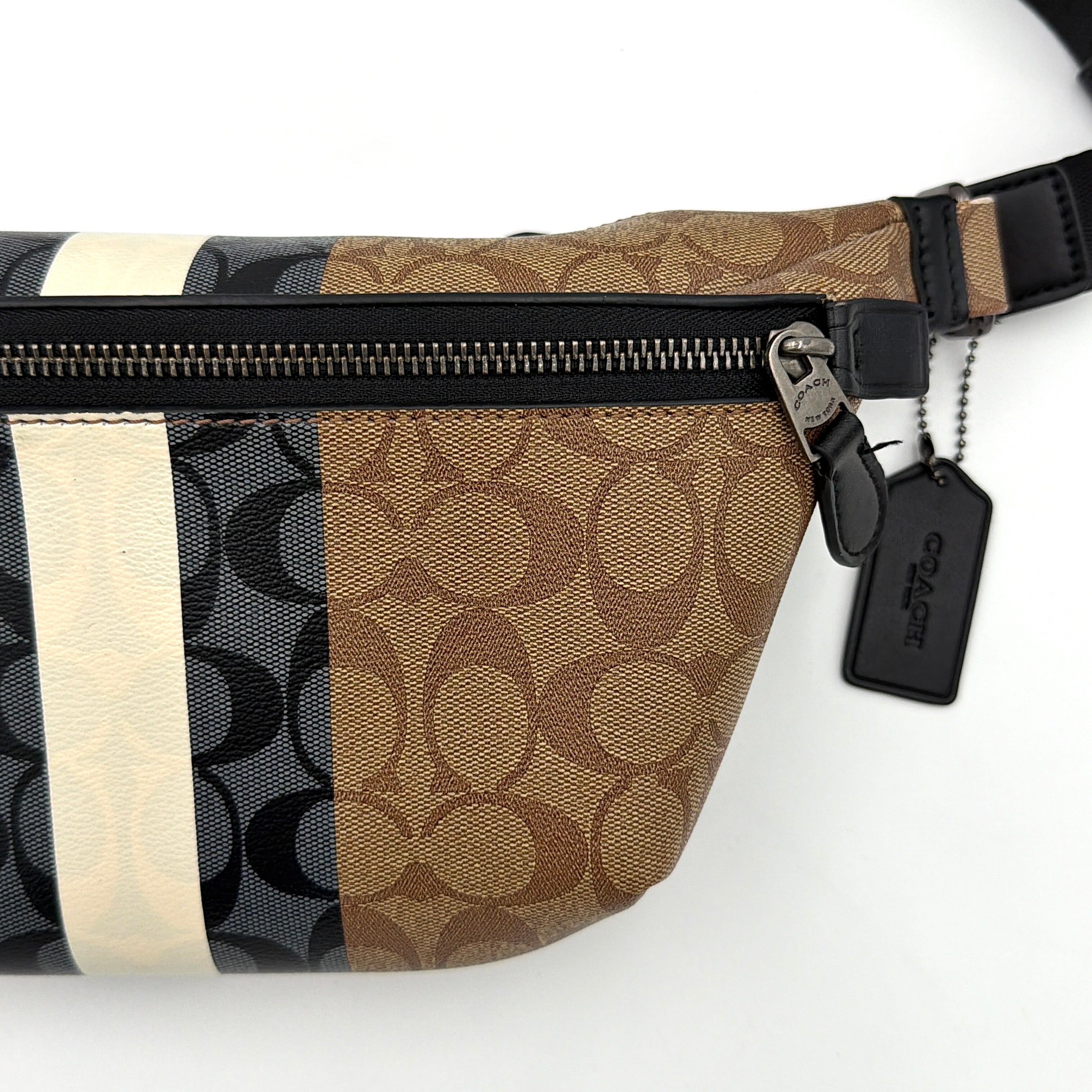 Coach Signature Warren Stripe Belt Bag in beige canvas with black and ivory vertical stripes and adjustable black strap.