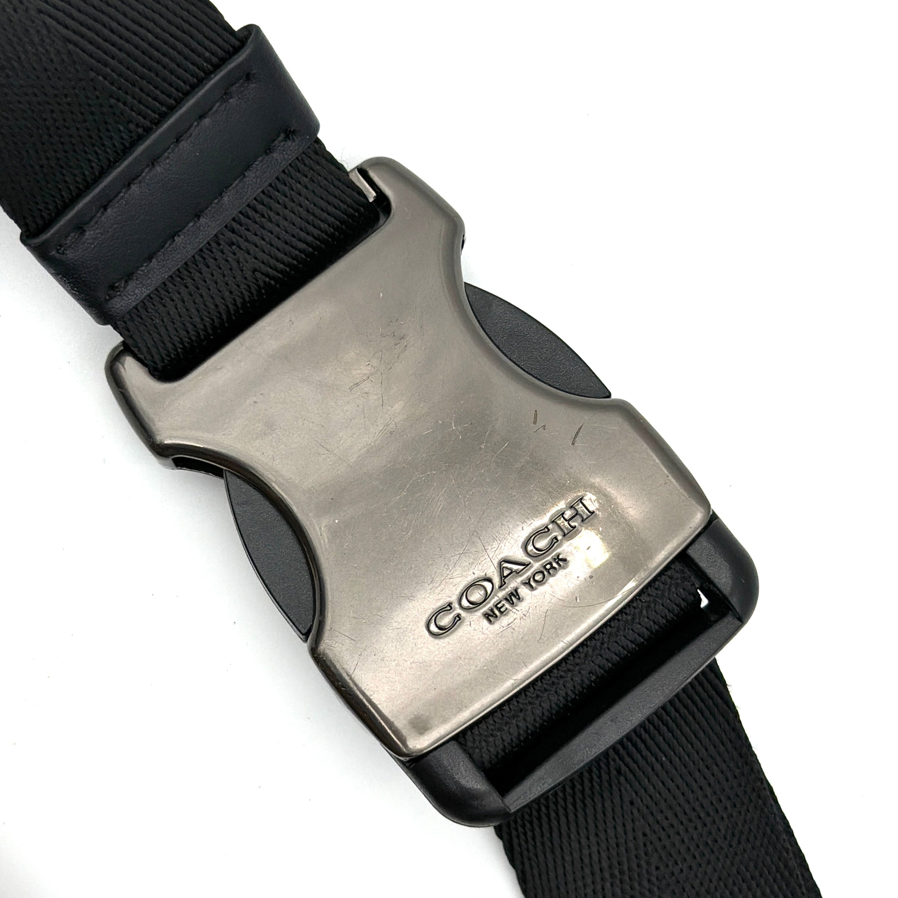 Coach Signature Warren Stripe Belt Bag in beige canvas with black and ivory vertical stripes and adjustable black strap.