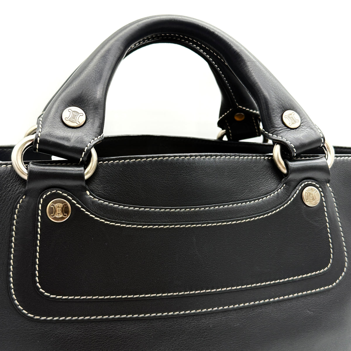 Celine Boogie black leather handbag with double handles and contrast stitching against a white background.