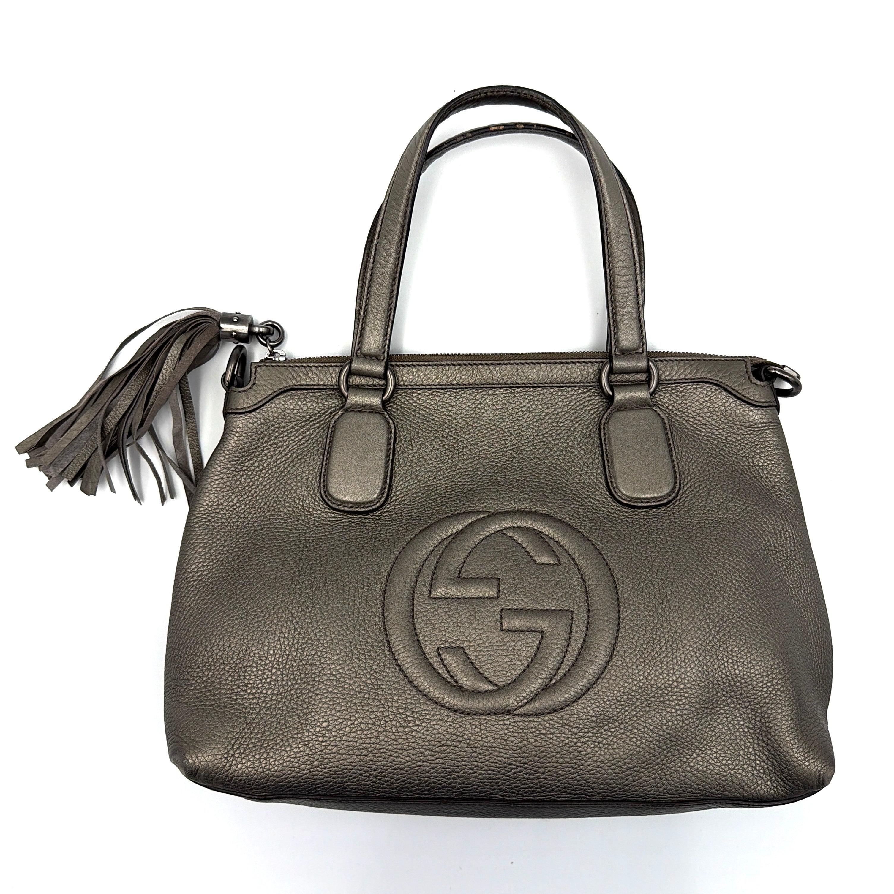 Gucci GG Soho Shoulder Bag in grey pebbled leather, featuring dual top handles, oversized stitched GG logo, and a leather tassel zip pull.