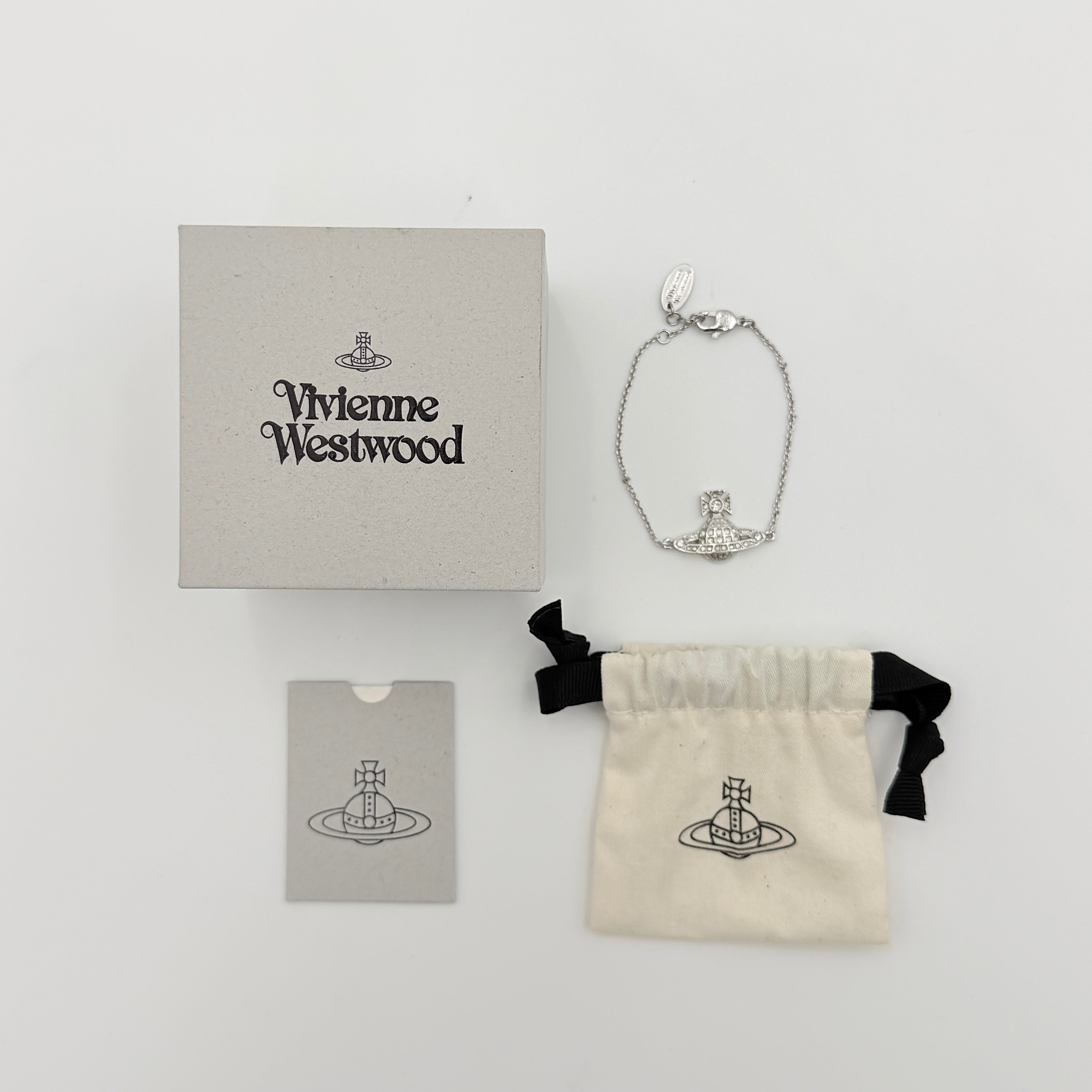 Vivienne Westwood silver rhinestone Orb bracelet with delicate chain and branded tag, shown against a clean background.