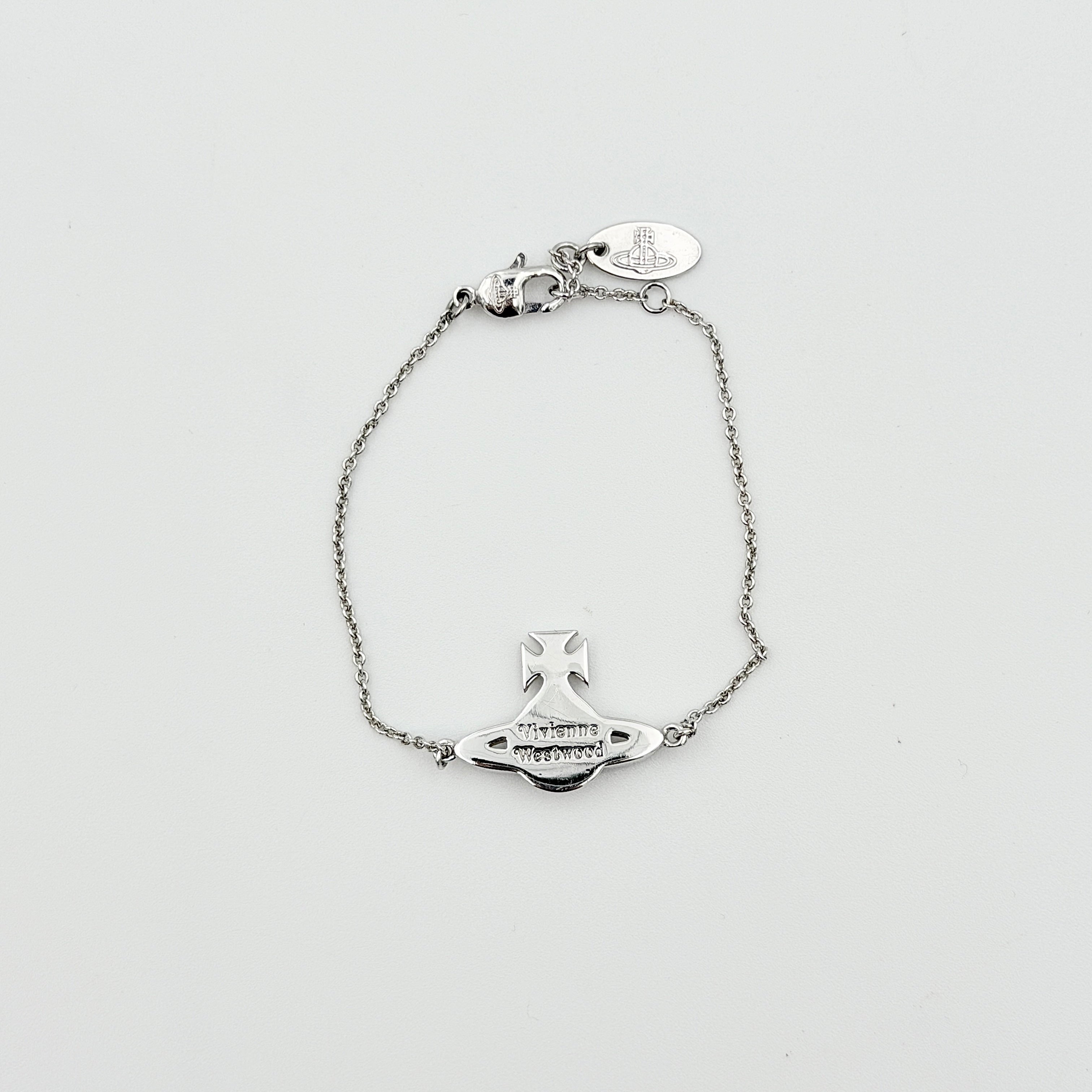 Vivienne Westwood silver rhinestone Orb bracelet with delicate chain and branded tag, shown against a clean background.