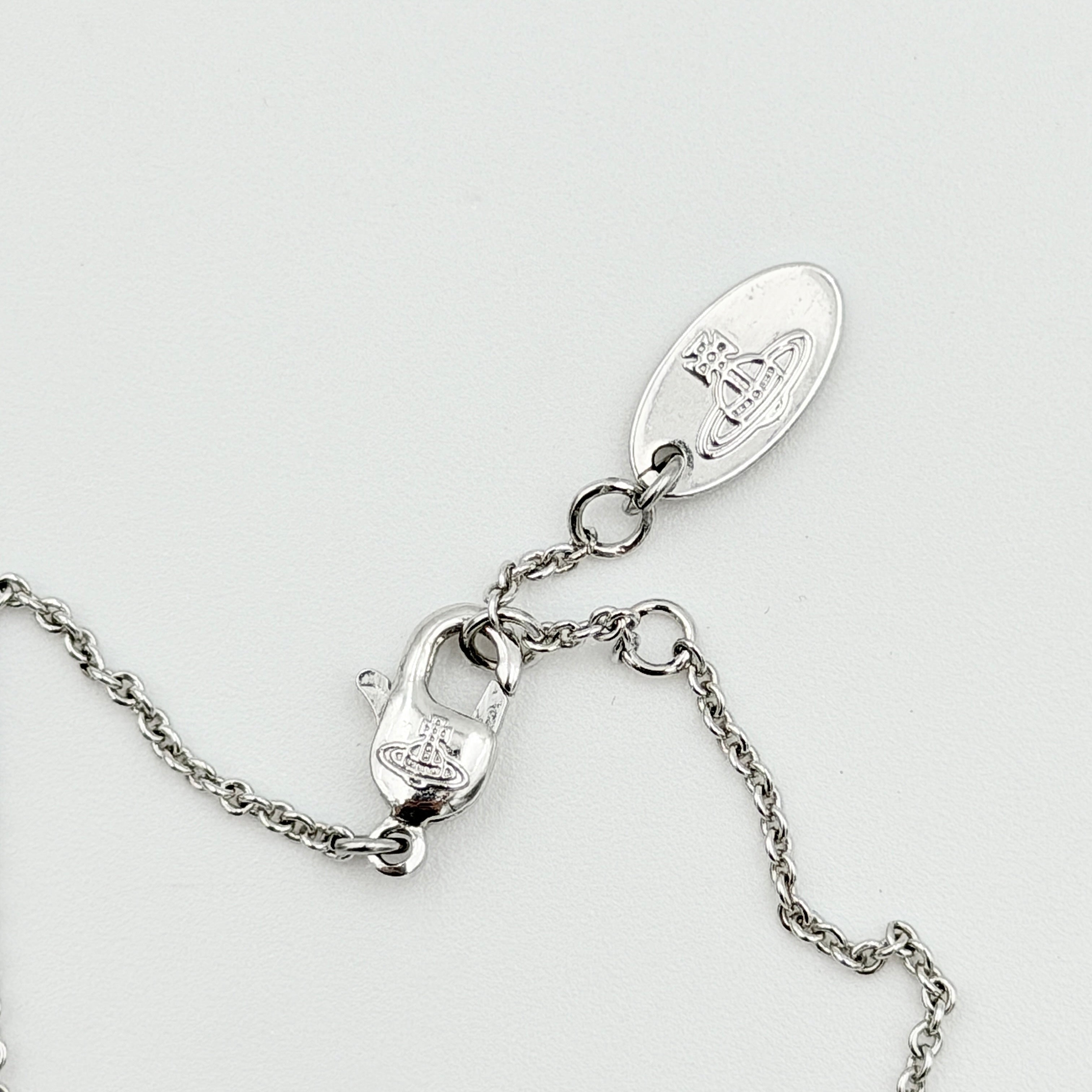 Vivienne Westwood silver rhinestone Orb bracelet with delicate chain and branded tag, shown against a clean background.