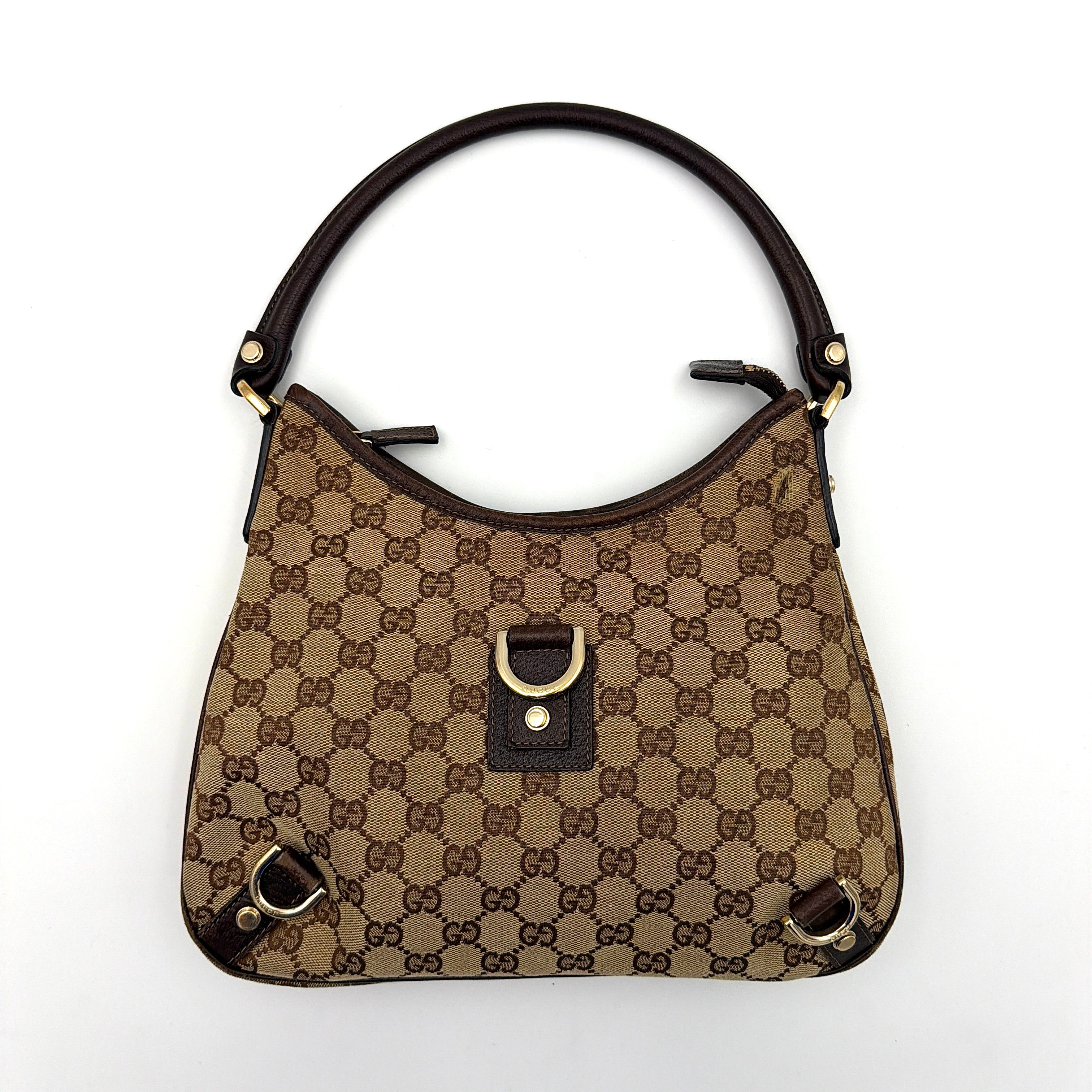 Front view of the Gucci GG Monogram Jacquard Abbey Hobo Bag in beige and brown canvas with gold-tone hardware and dark brown leather trim.