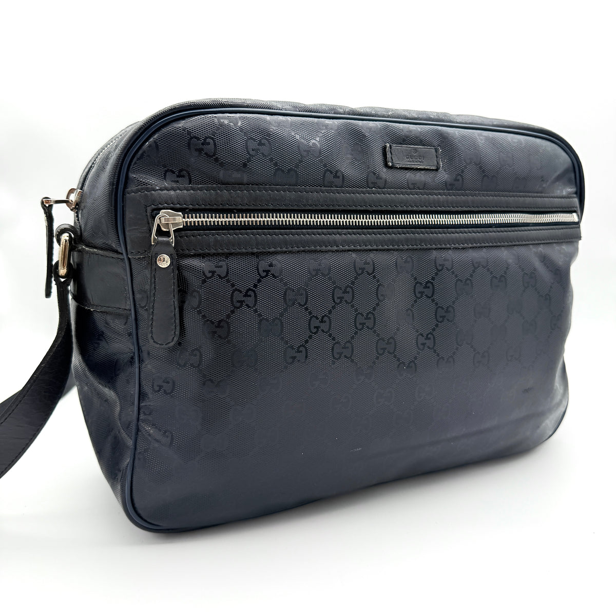 Gucci black GG Monogram Imprime messenger crossbody bag with leather strap and silver-tone hardware, shown against a white background.