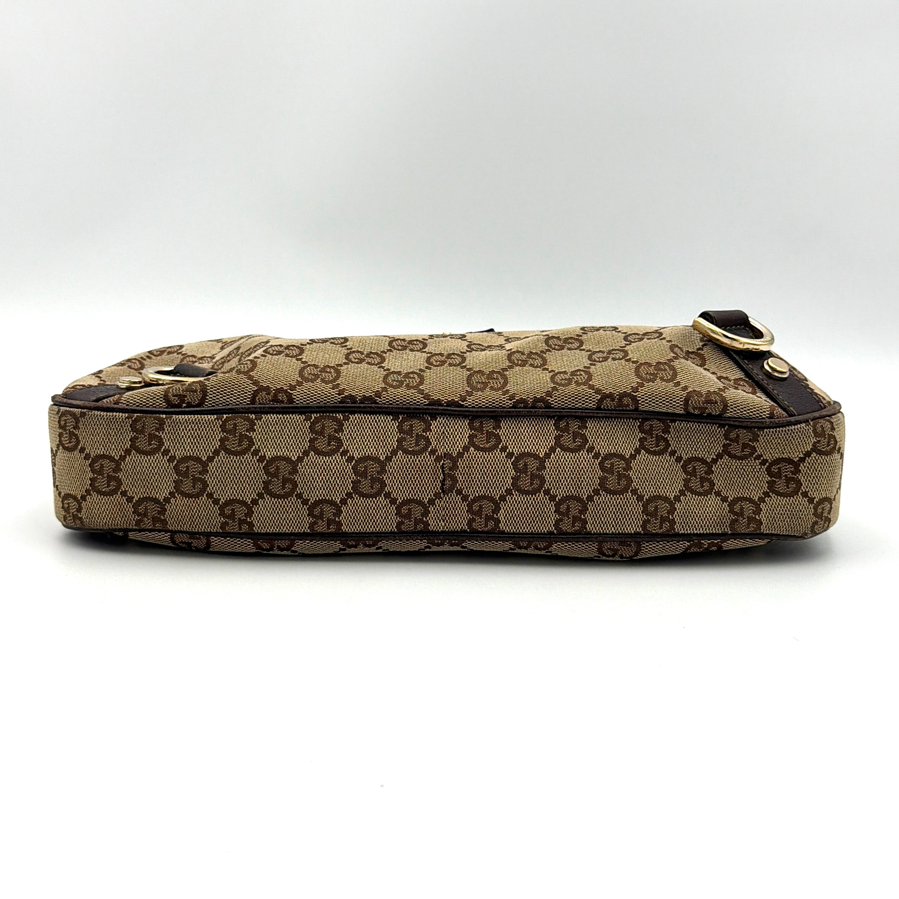 Front view of the Gucci GG Monogram Jacquard Abbey Hobo Bag in beige and brown canvas with gold-tone hardware and dark brown leather trim.