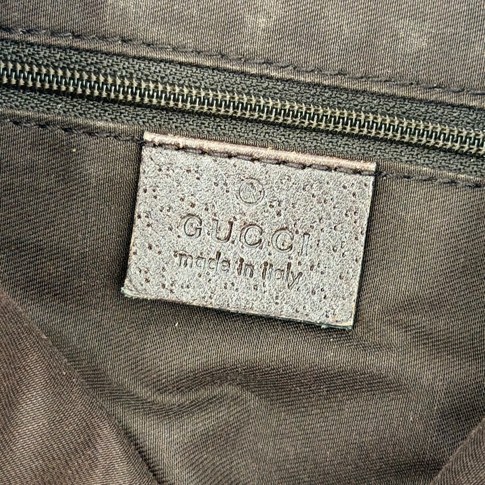Front view of the Gucci GG Monogram Jacquard Abbey Hobo Bag in beige and brown canvas with gold-tone hardware and dark brown leather trim.