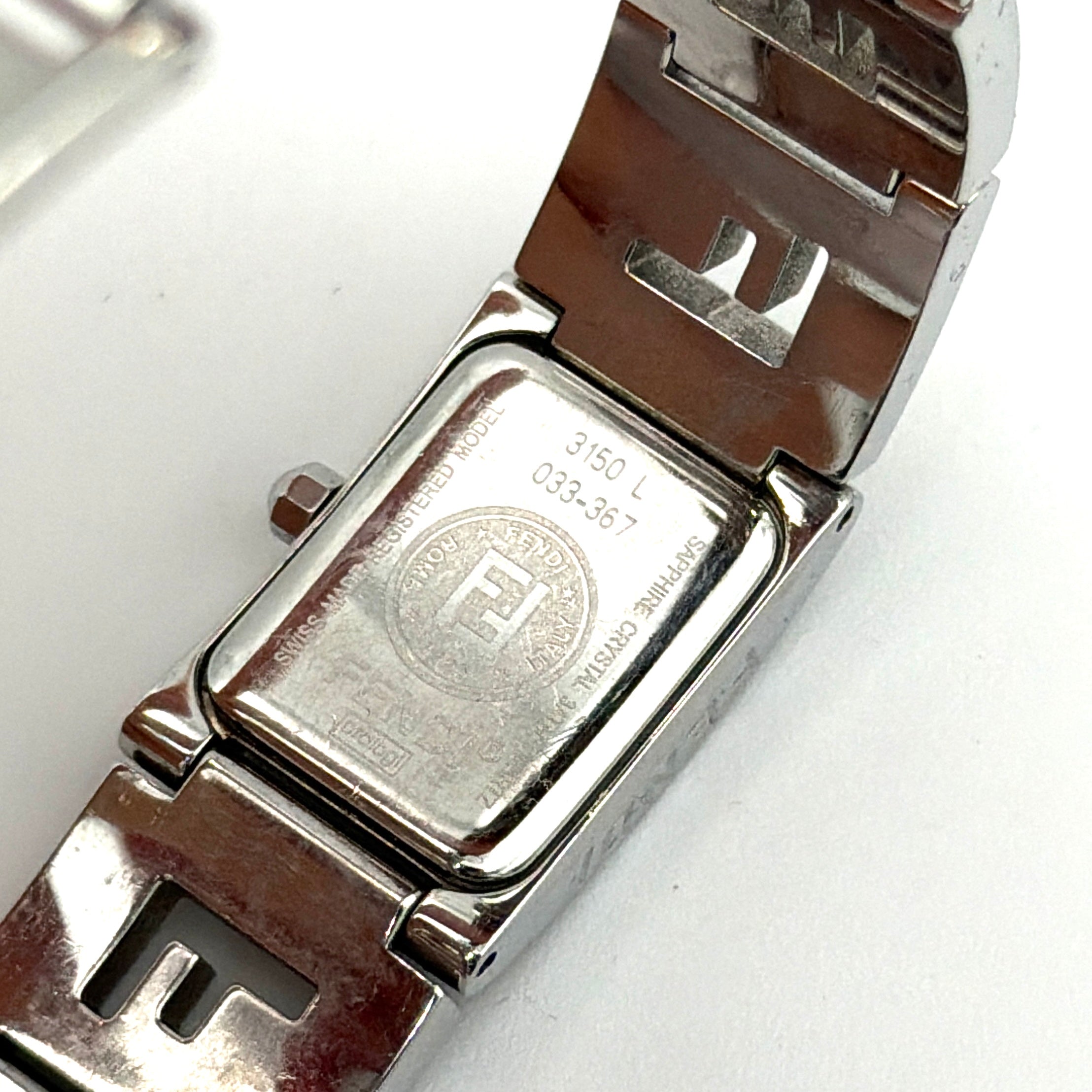 Fendi 3150L FF Logo Belt Watch in silver with a black dial, presented in a black Fendi box with gold logo accents.