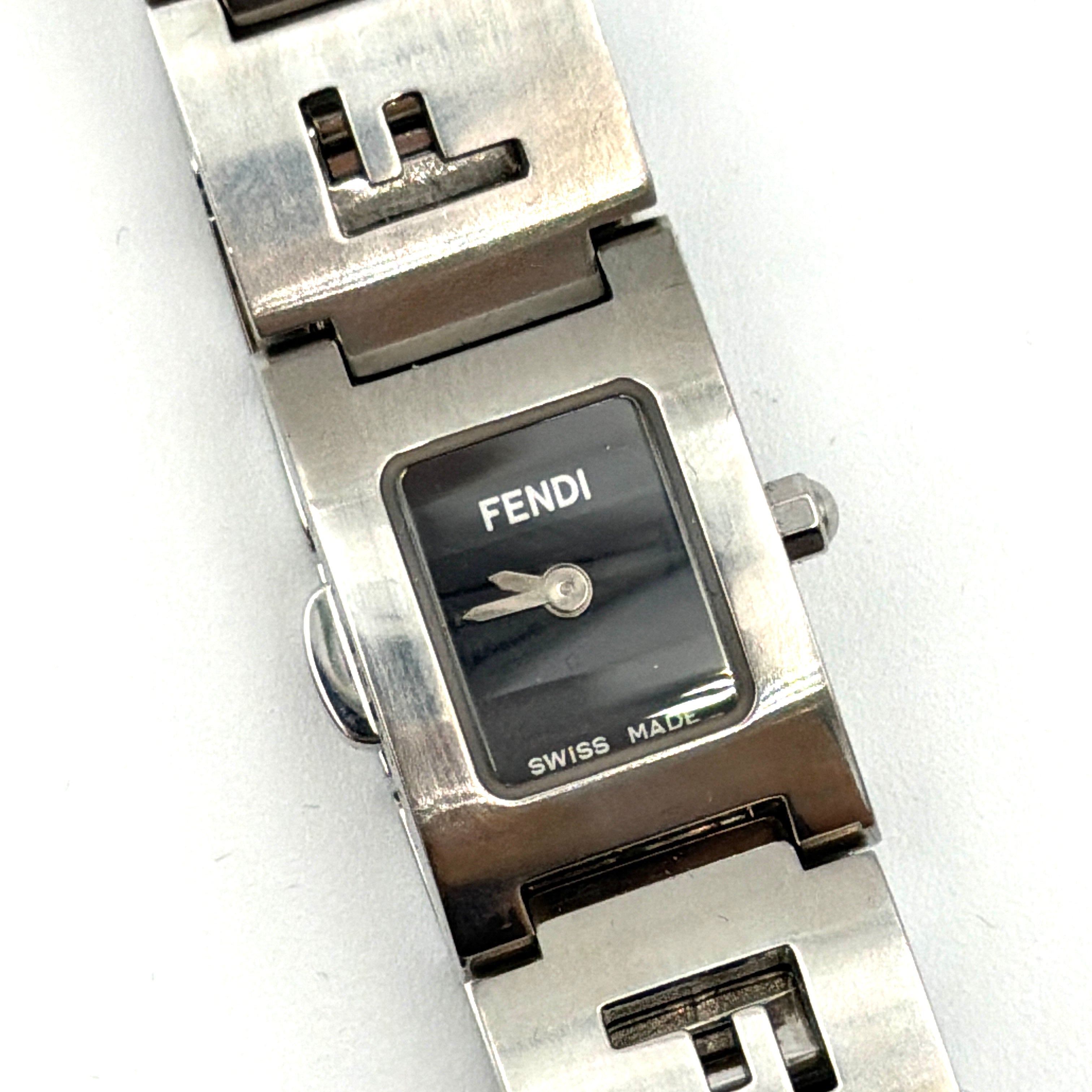 Fendi 3150L FF Logo Belt Watch in silver with a black dial, presented in a black Fendi box with gold logo accents.