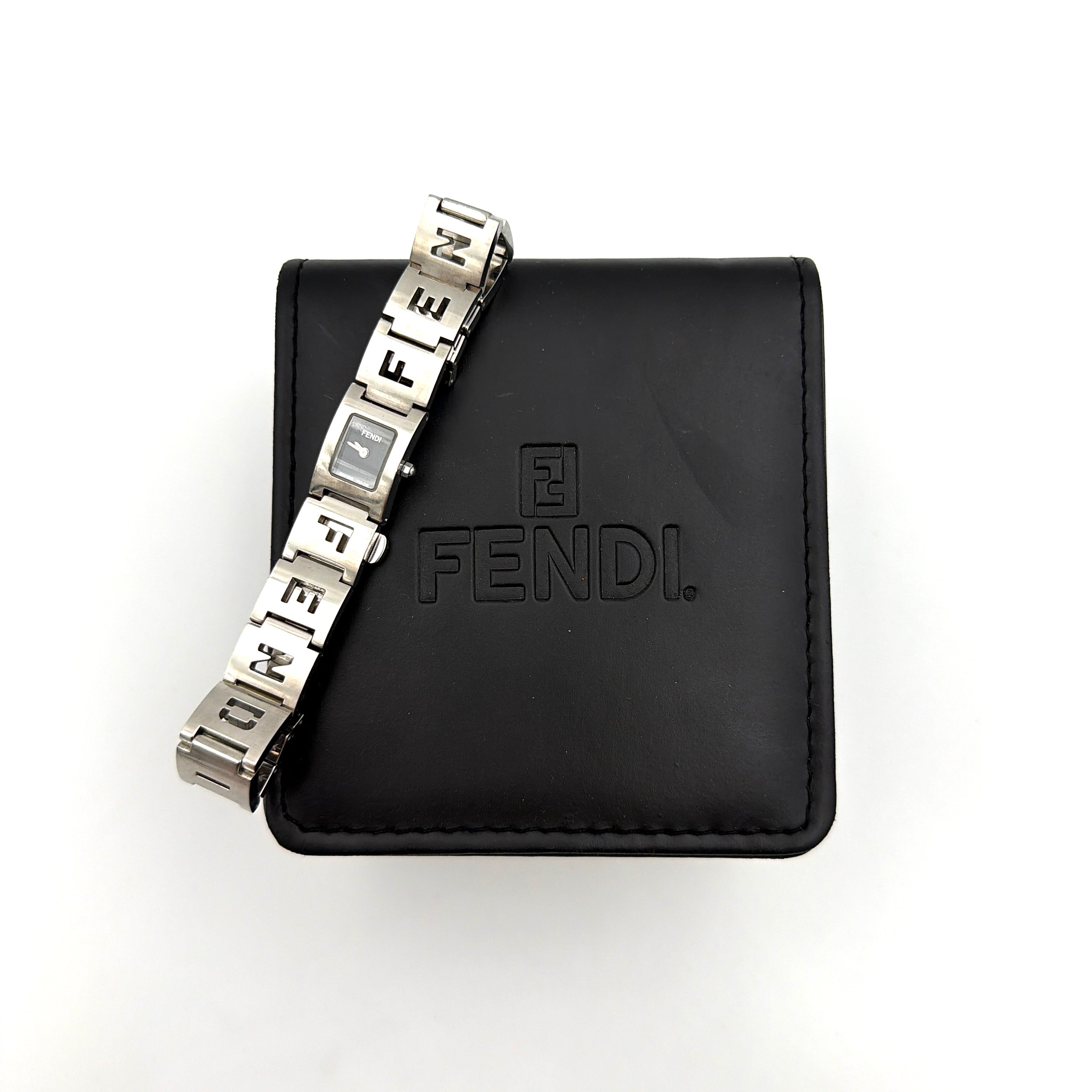 Fendi 3150L FF Logo Belt Watch in silver with a black dial, presented in a black Fendi box with gold logo accents.