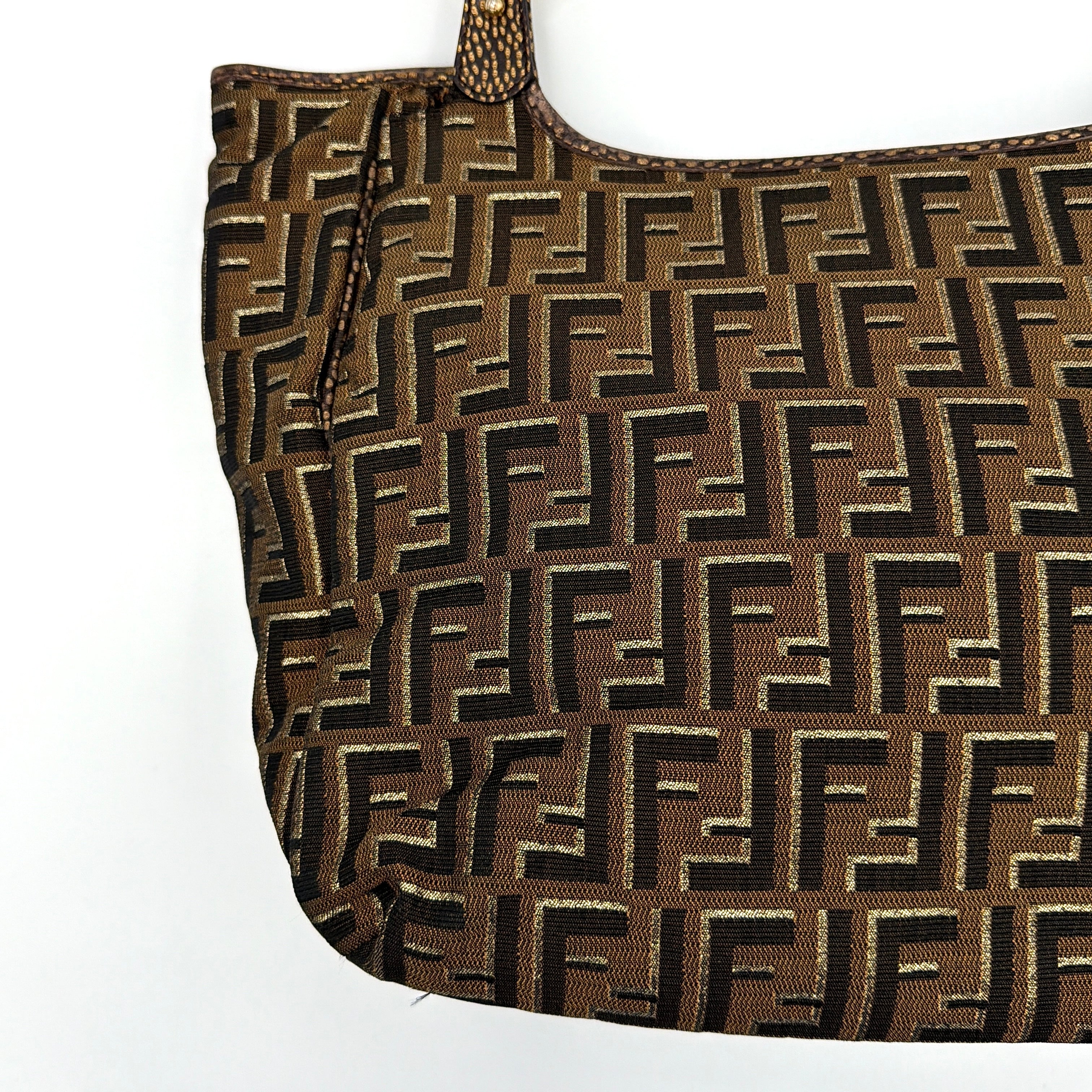 The Fendi FF Zucca Chef Shoulder Bag in brown jacquard canvas with all-over FF monogram, leather trim, and gold-tone ring handles.