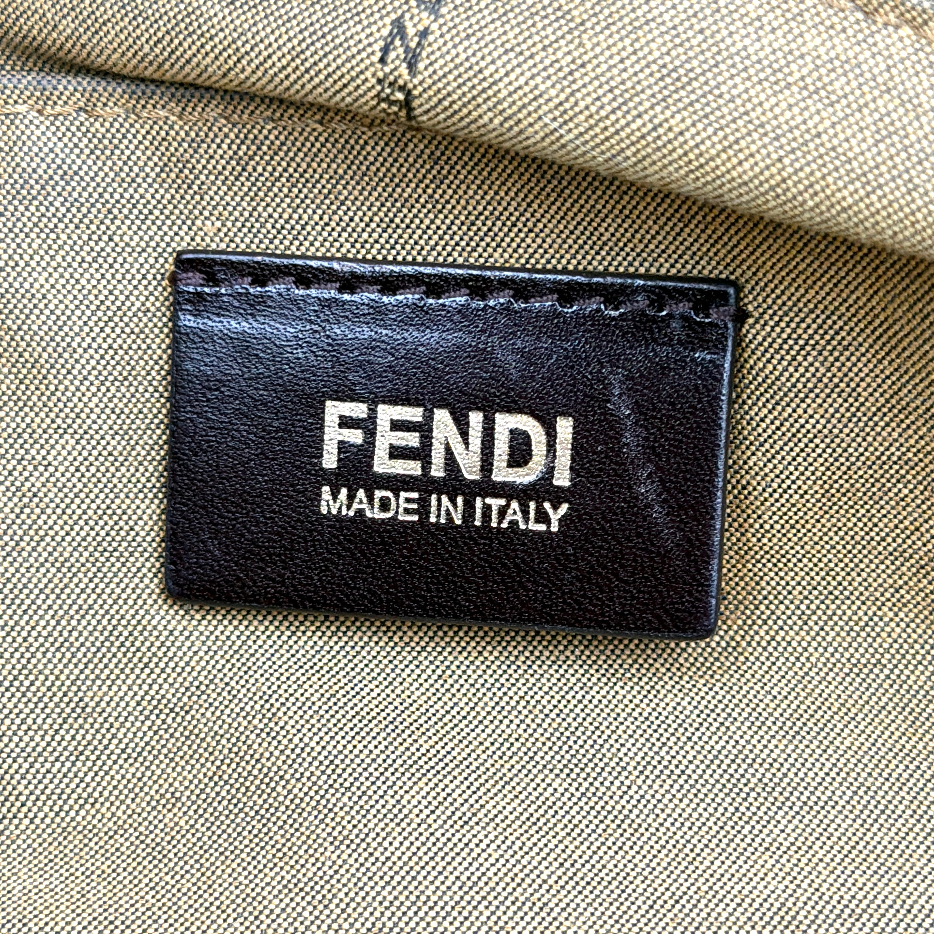 The Fendi FF Zucca Chef Shoulder Bag in brown jacquard canvas with all-over FF monogram, leather trim, and gold-tone ring handles.