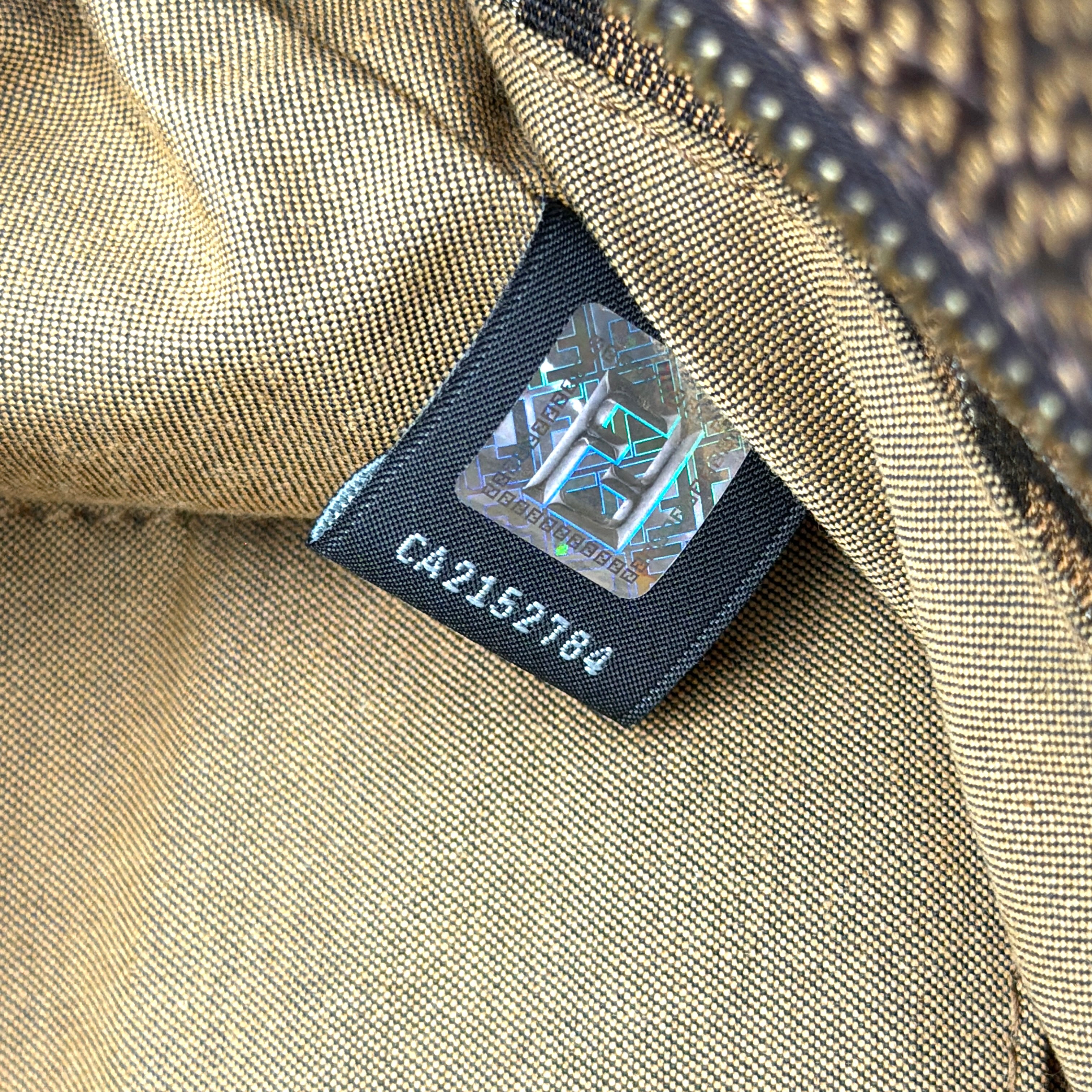 The Fendi FF Zucca Chef Shoulder Bag in brown jacquard canvas with all-over FF monogram, leather trim, and gold-tone ring handles.