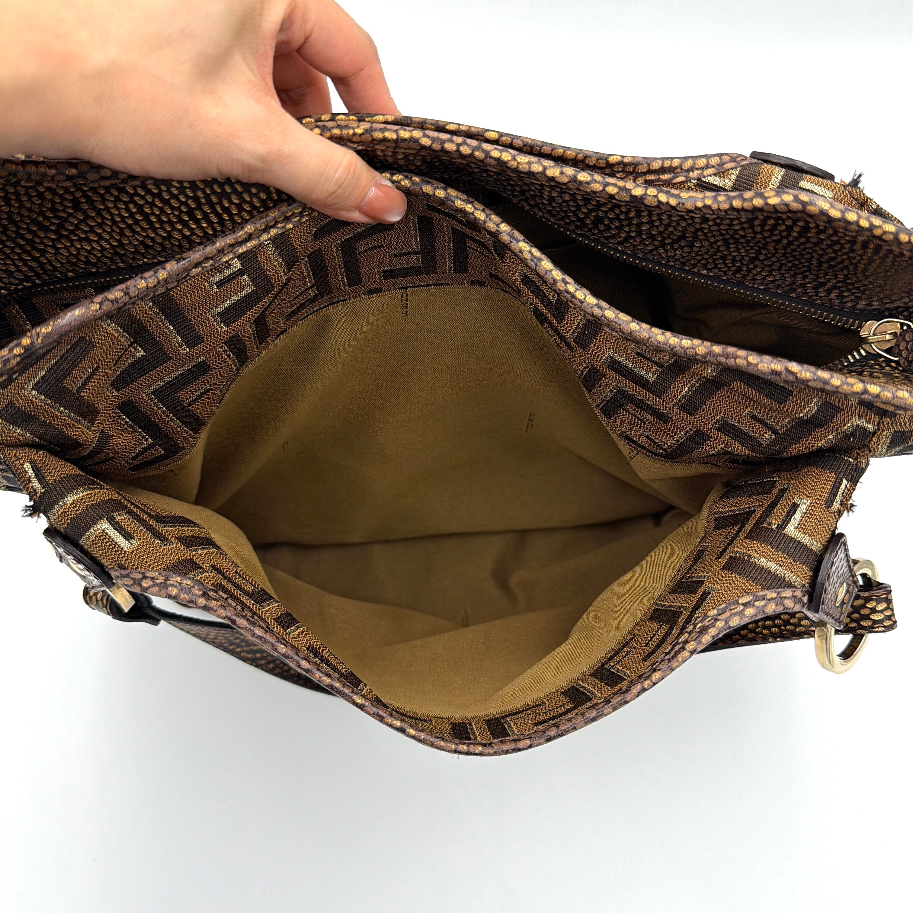 The Fendi FF Zucca Chef Shoulder Bag in brown jacquard canvas with all-over FF monogram, leather trim, and gold-tone ring handles.