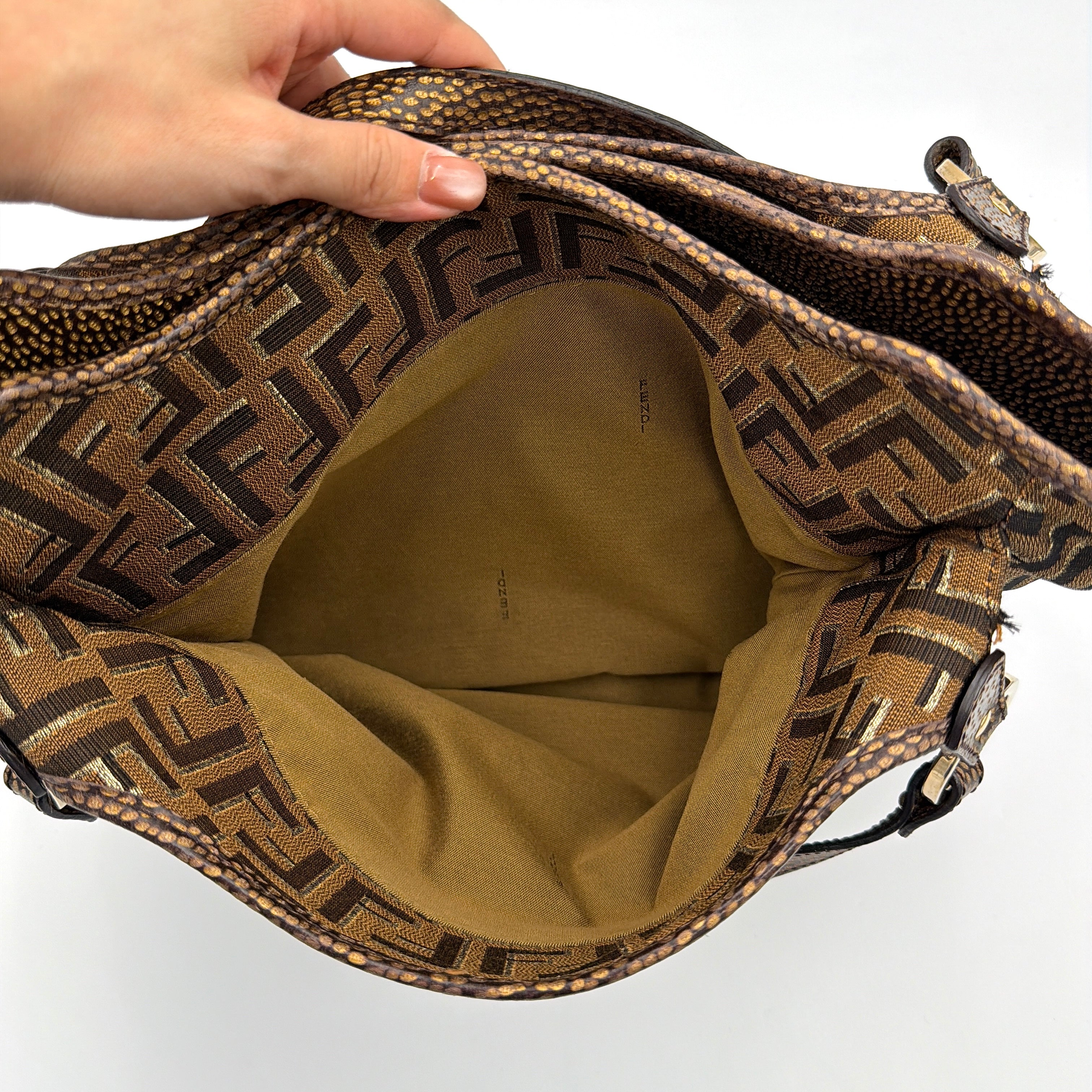 The Fendi FF Zucca Chef Shoulder Bag in brown jacquard canvas with all-over FF monogram, leather trim, and gold-tone ring handles.