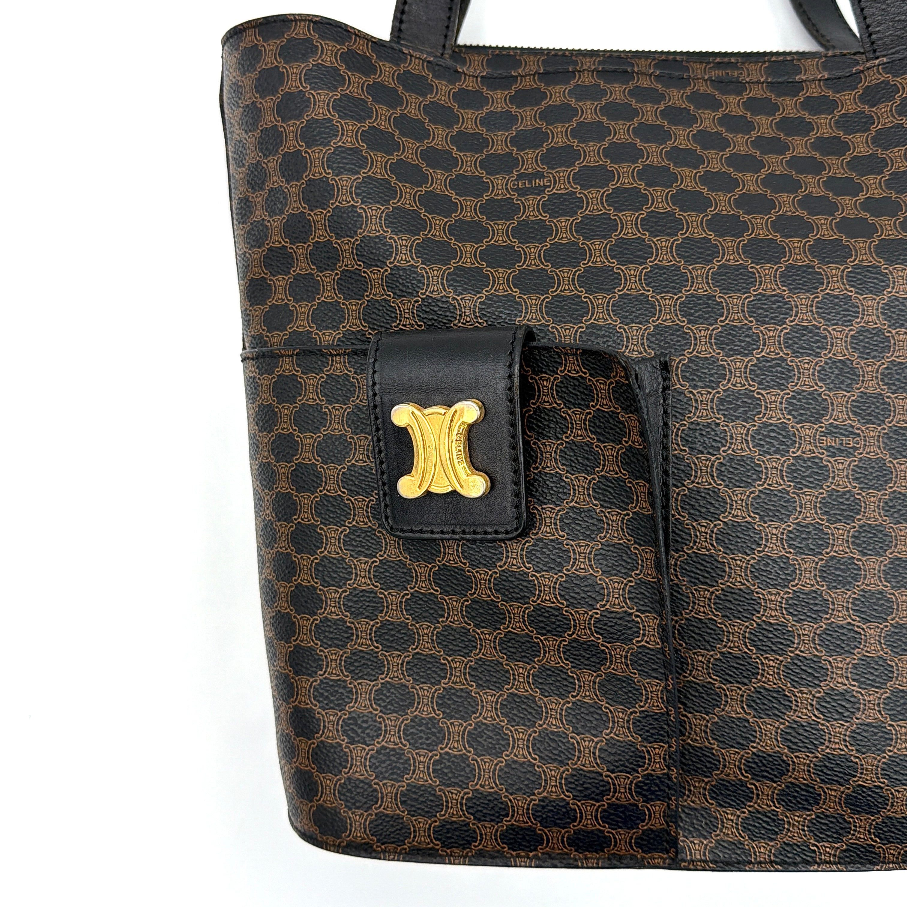 Celine Macadam Blason Tote Bag in brown coated canvas with all-over Macadam motif, black leather trim, and gold-tone Blason emblem front pocket.