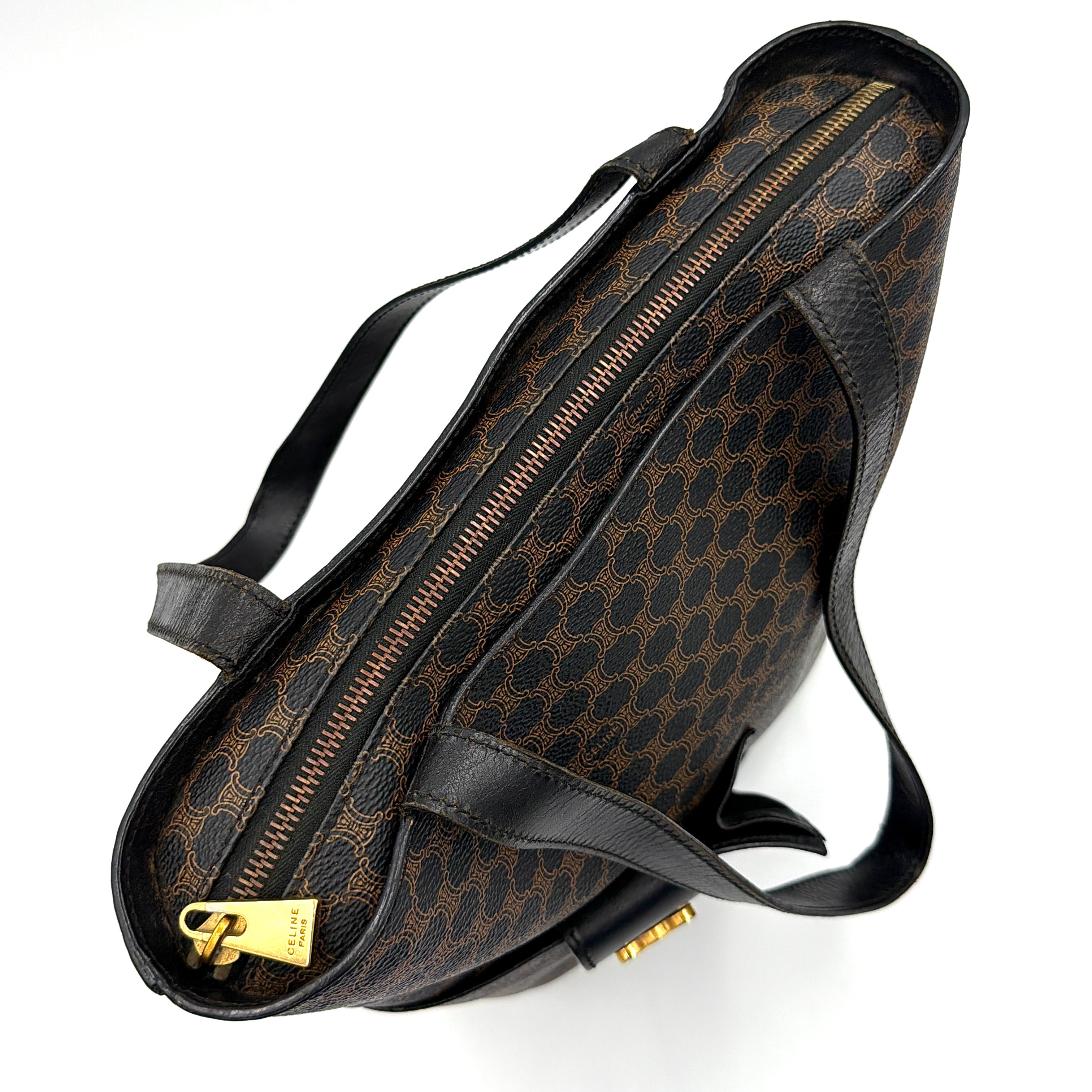 Celine Macadam Blason Tote Bag in brown coated canvas with all-over Macadam motif, black leather trim, and gold-tone Blason emblem front pocket.