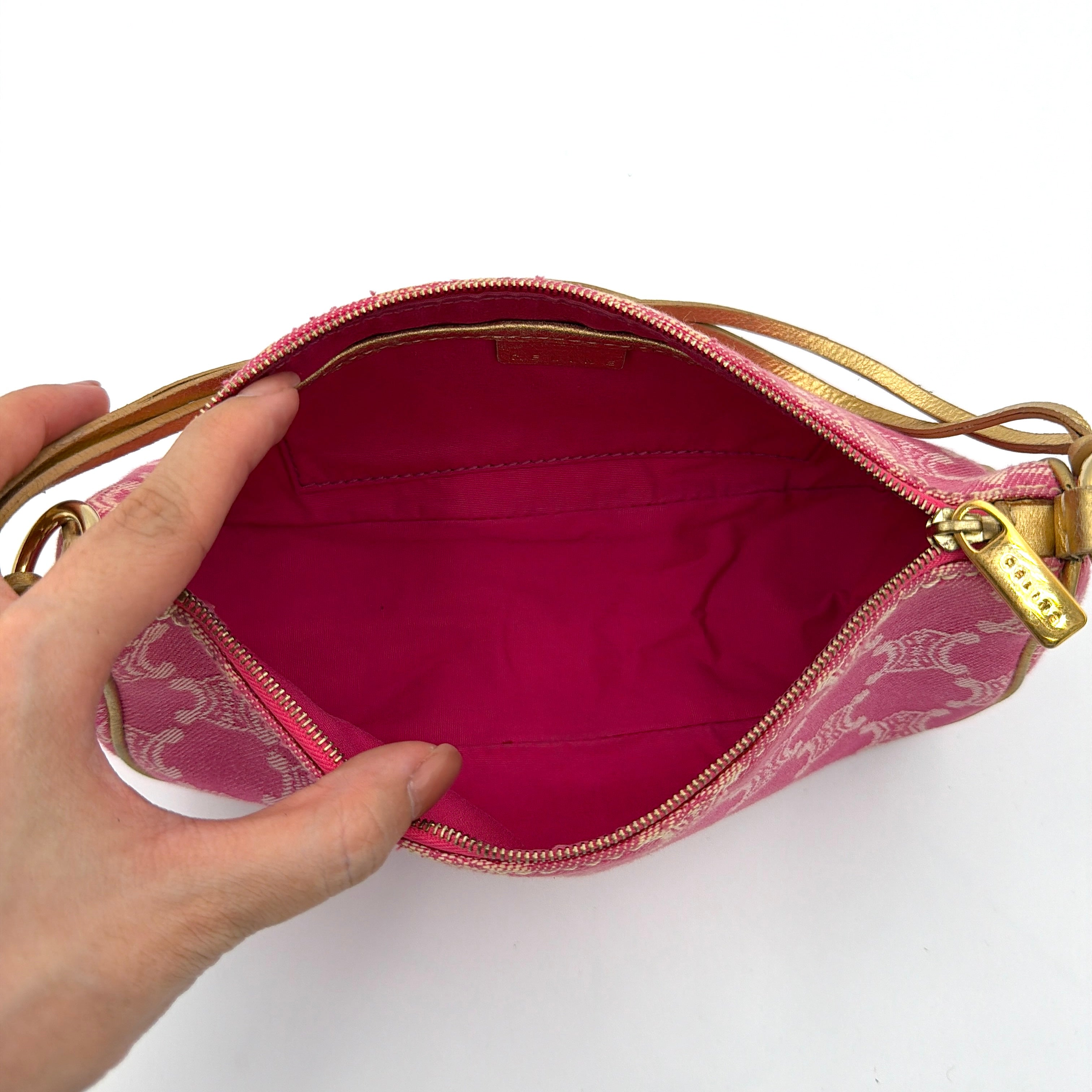 Front view of the Celine Macadam pink denim shoulder bag with gold-tone leather strap and triomphe monogram print.